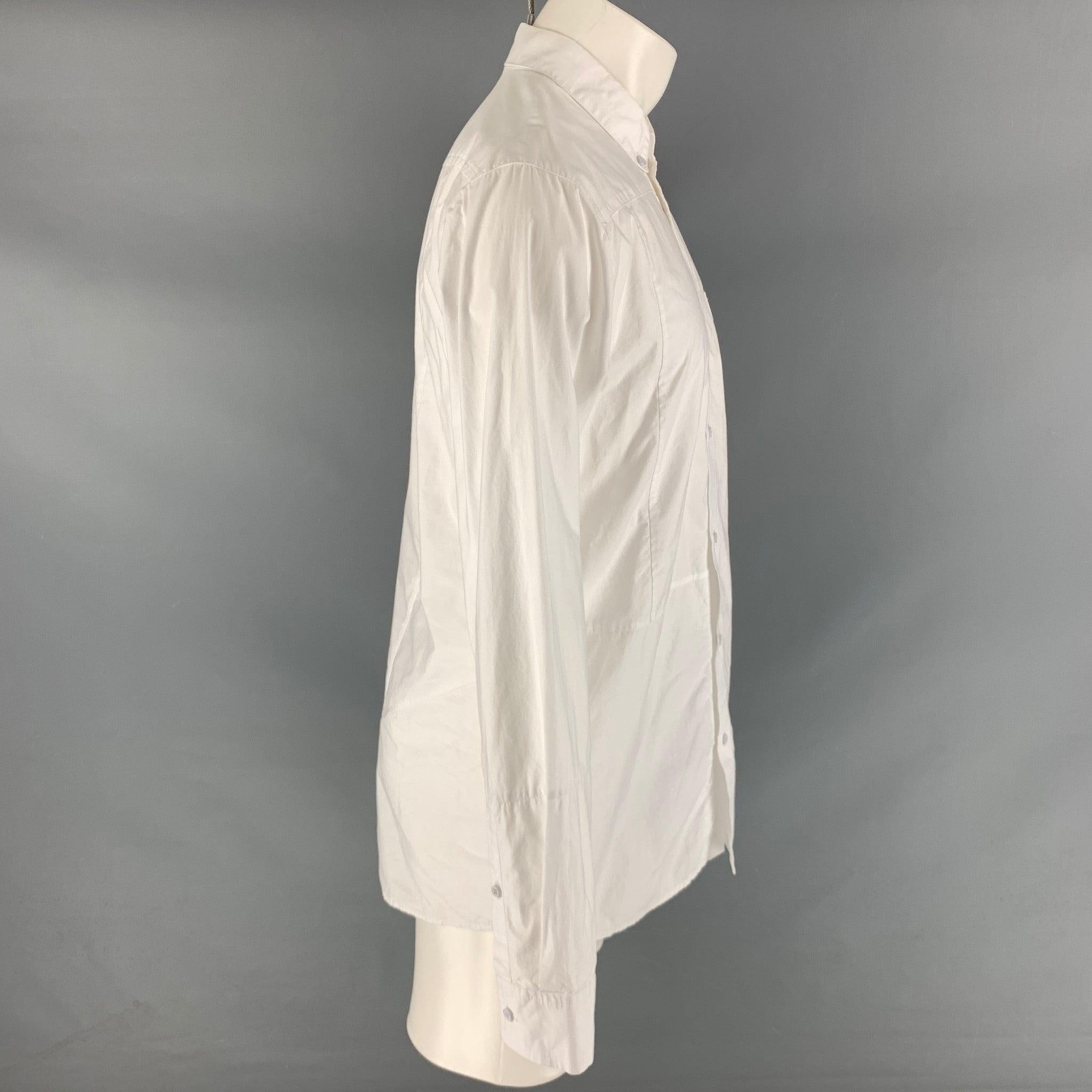 ALEXANDER WANG long sleeve shirt comes in a white cotton featuring a straight collar, asymmetric seams, and a white button closure.Excellent Pre-Owned Condition. 

Marked:   S
 

Measurements: 
 
Shoulder: 19 inches Chest: 42 inches Sleeve: 25.5
