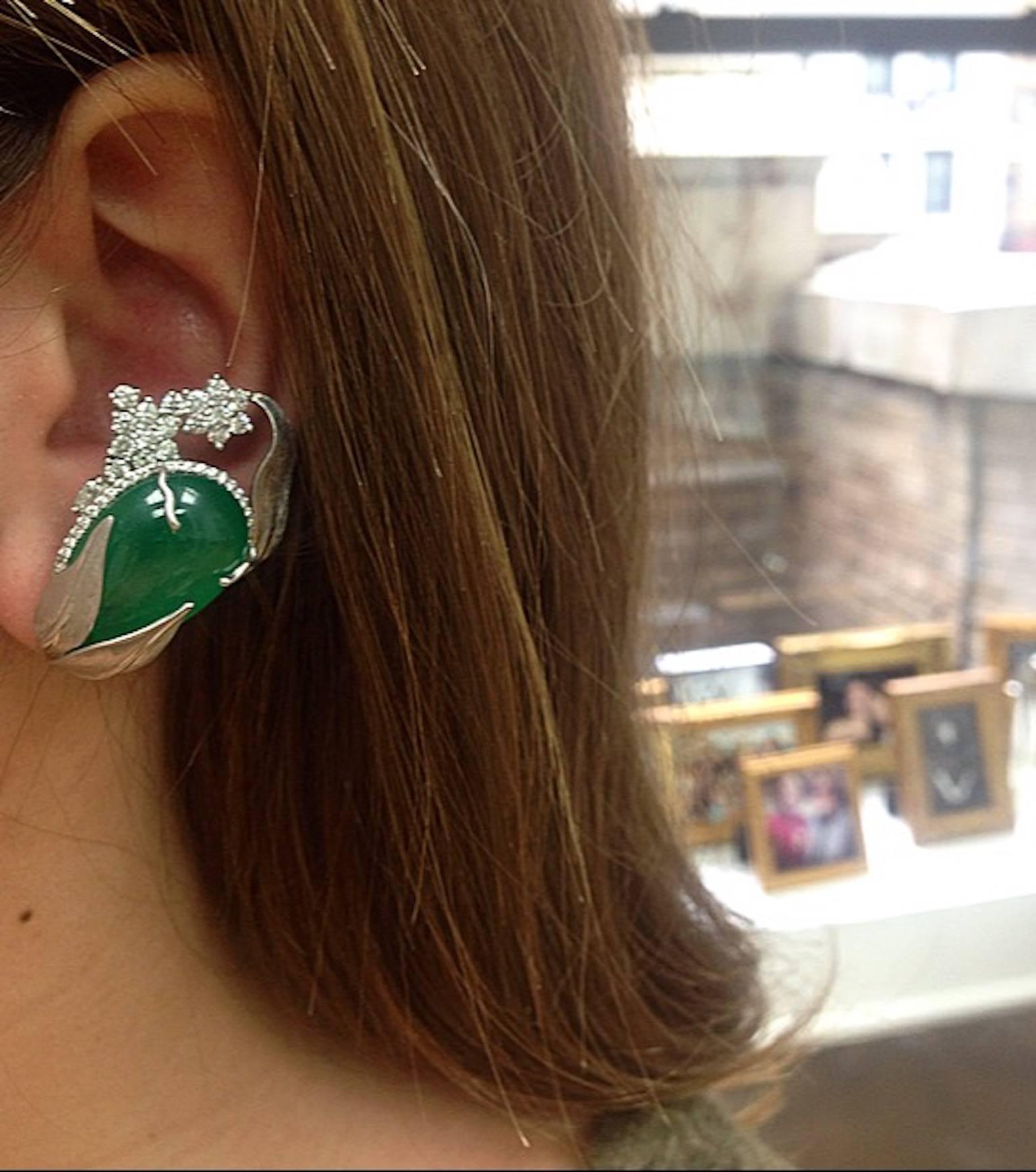 Dramatic, one-of-a-kind Alexandra Mor cuff earrings featuring matching Drop-shaped natural green Emeralds weighing 52.58 Cts., encircled by Alexandra Mor's signature details of 1mm floating Diamond melee, and knife-edged wire. Earrings are further