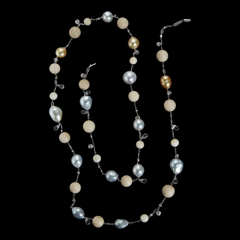 An Alexandra Mor One-Of-a-Kind necklace featuring 12 South Sea pearls measuring from 24 to 21 mm long ,  265.88 carats of Tagua Beads, White Topaz Briolettes and diamonds. 18 Karat White Gold chain and 18 Karat Yellow Gold Alexandra Mor logo