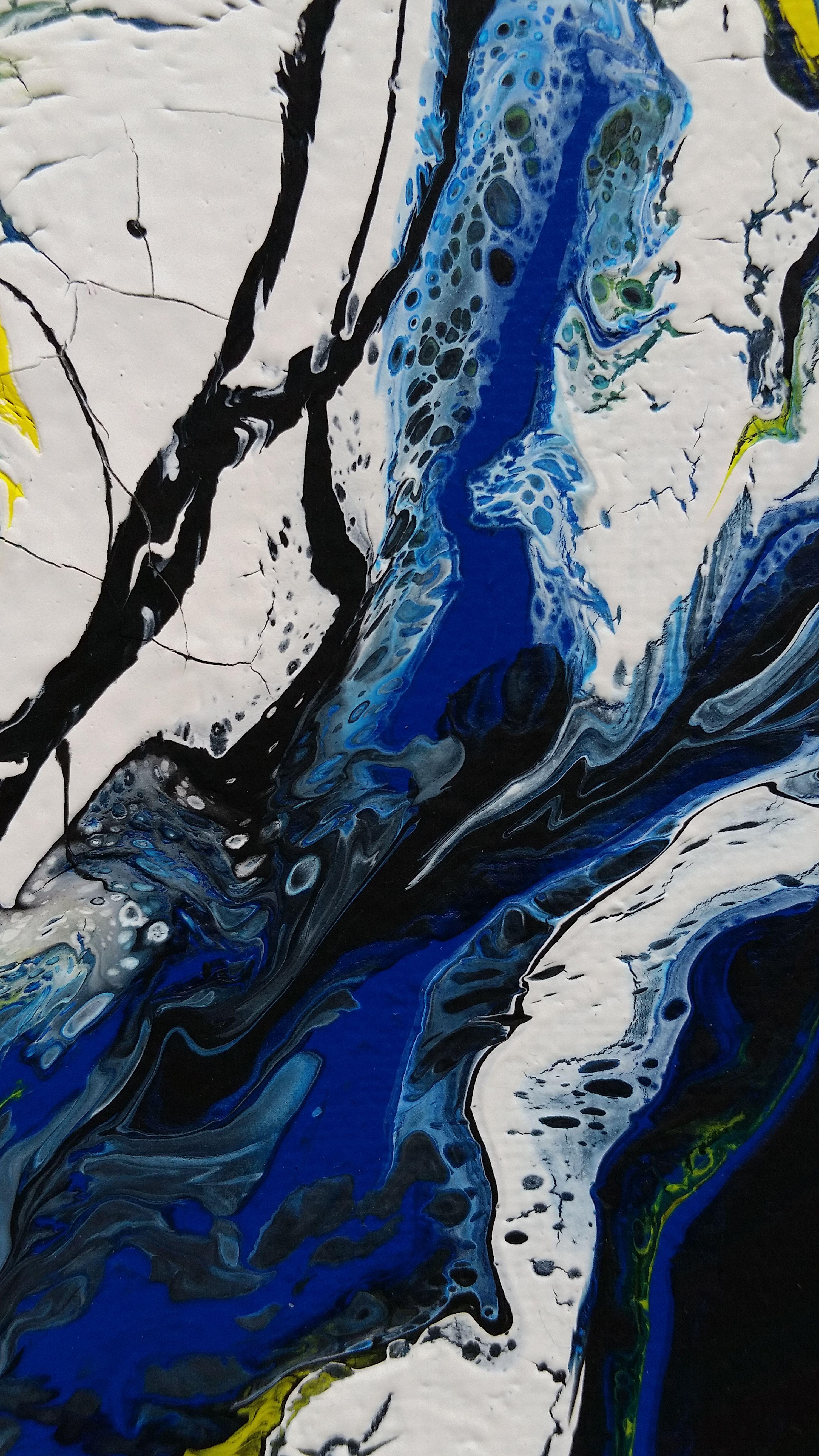 A dazzling abstract expressionism painting with bright yellow and a variety of blue hues flowing together. White and cracked textures resemble ice caps with the movement and blue color palette representing water, and black and yellow representing