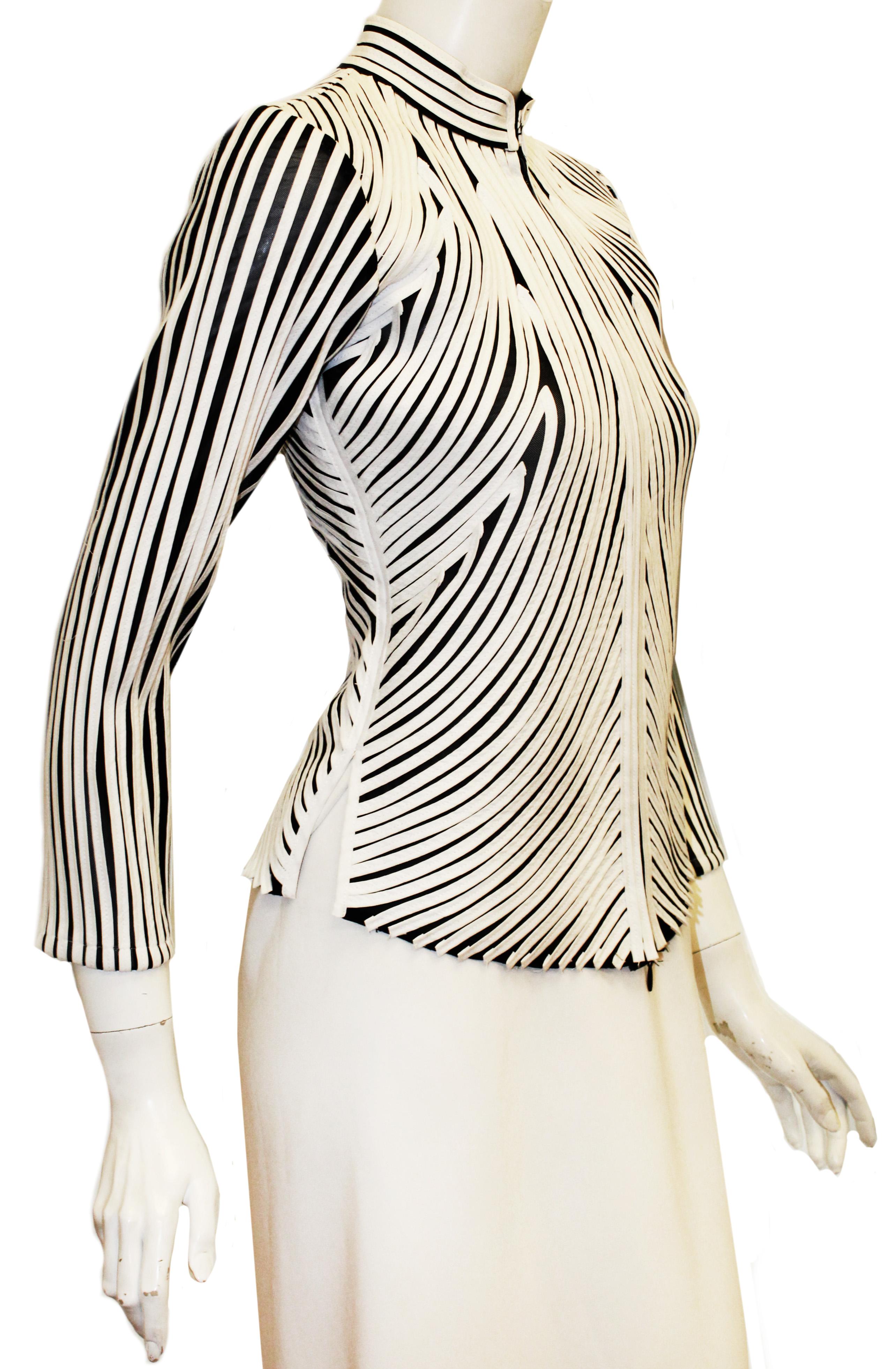 Alexandra Rosati black jacket with white applique top stitched in a modern abstract design on black sheer jacket.   The mandarin collar gives this garment an oriental vibe.  For closure, a zipper is located at front of jacket.  White applique is