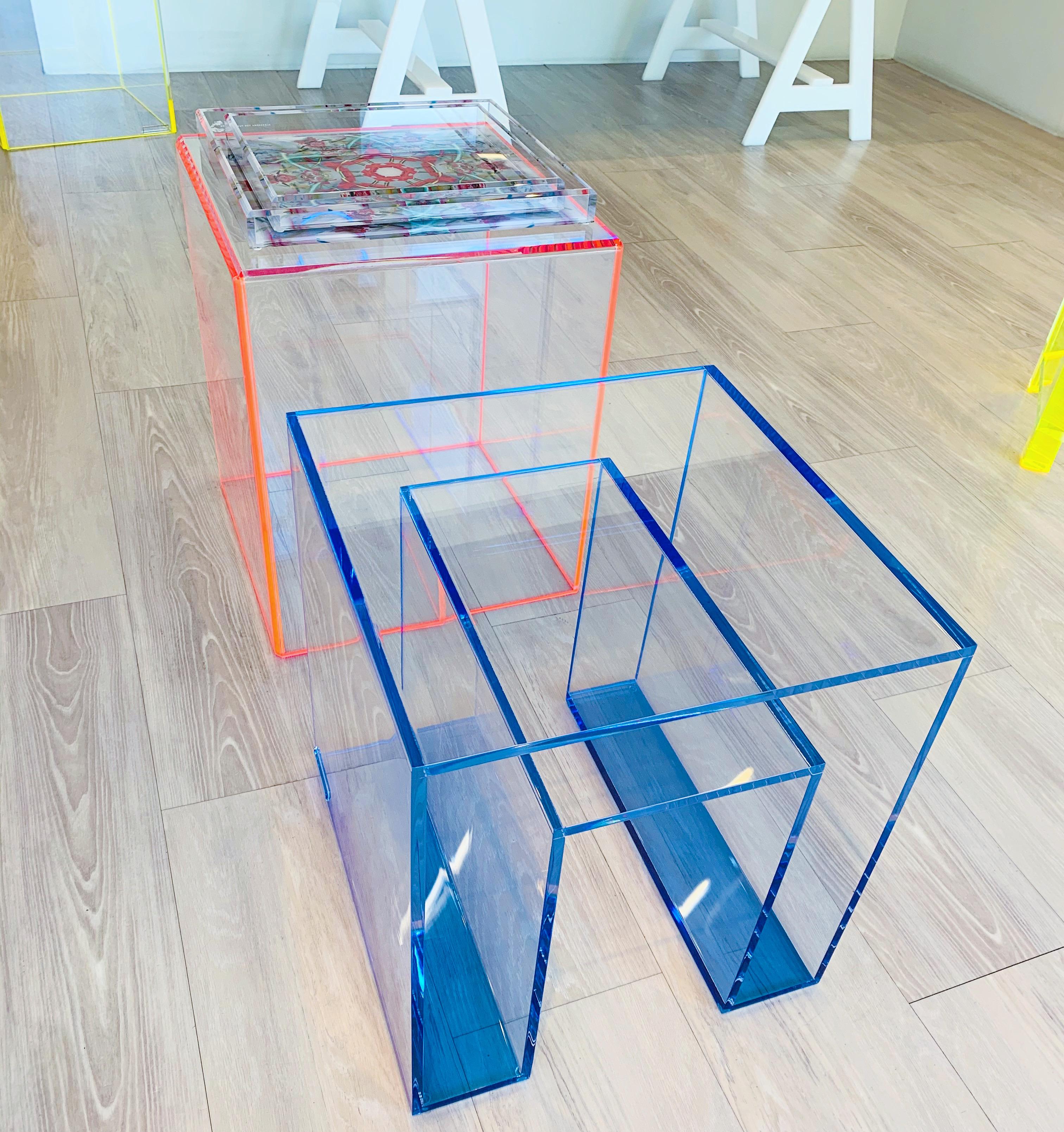 The Alexandra Von Furstenberg Brilliant Side Table in Lagoon and Clear lucite. This sleek accent table is inspired by our iconic console, highlighting its signature clean lines with a pop of color. Its minimalist design is modern and chic,