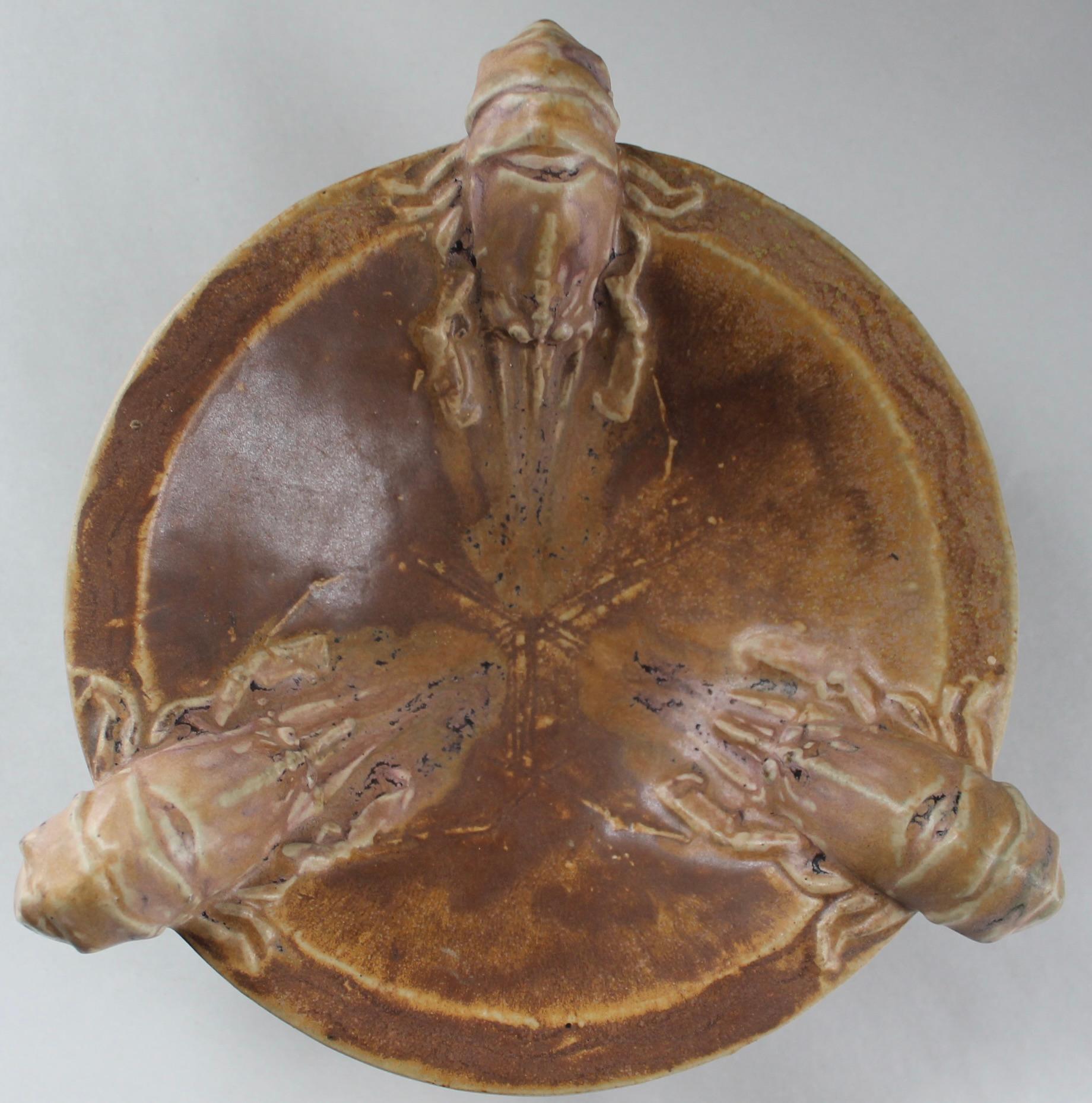 Low based bowl, brown ocher varied glaze with three Crawfish on the rim.
Signed: Charles Greber..