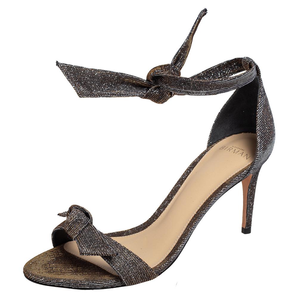 These sandals by Alexandre Birman are edgy and look fashionable and chic. Crafted from lurex fabric, they come in black and gold and are absolutely gorgeous. They feature bow detailing on the straps and have ankle wrap closure. Lined with the finest