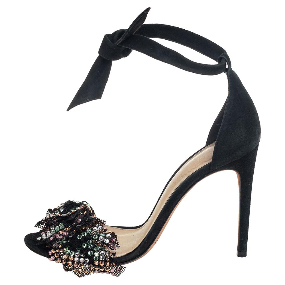 These Clarita sandals by Alexandre Birman are edgy and look fashionable and chic. Crafted from suede and mesh, they come in a black shade. They feature dazzling embellishments on the vamp straps and have ankle ties. Lined with the finest quality
