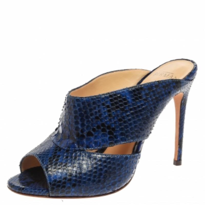 Charm your way to all your social gatherings in this pair of Latoya mules from Alexandre Birman. Crafted from exotic python skin in a blue hue, they carry a feminine design with cutout vamps and high stiletto heels. (NOTE: FOR UAE CUSTOMERS ONLY)