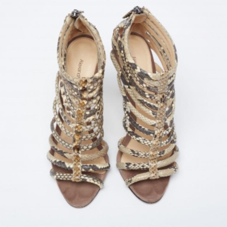These glamorous sandals from Alexandre Birman will make sure you look absolutely divine. They are finely crafted from python-embossed leather in an open-toe silhouette with a cut-out cage design. They are fastened using rear zippers and come