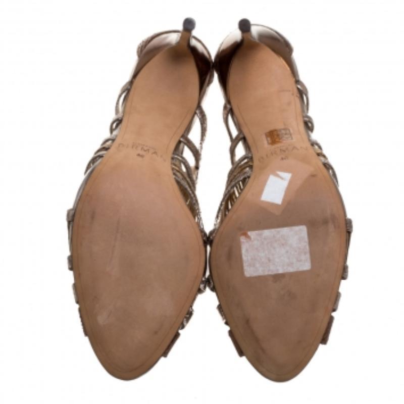 These glamorous sandals from Alexandre Birman will make sure you look absolutely divine. They are finely crafted from python-embossed leather in an open-toe silhouette with a cut-out cage design. They are fastened using rear zippers and come