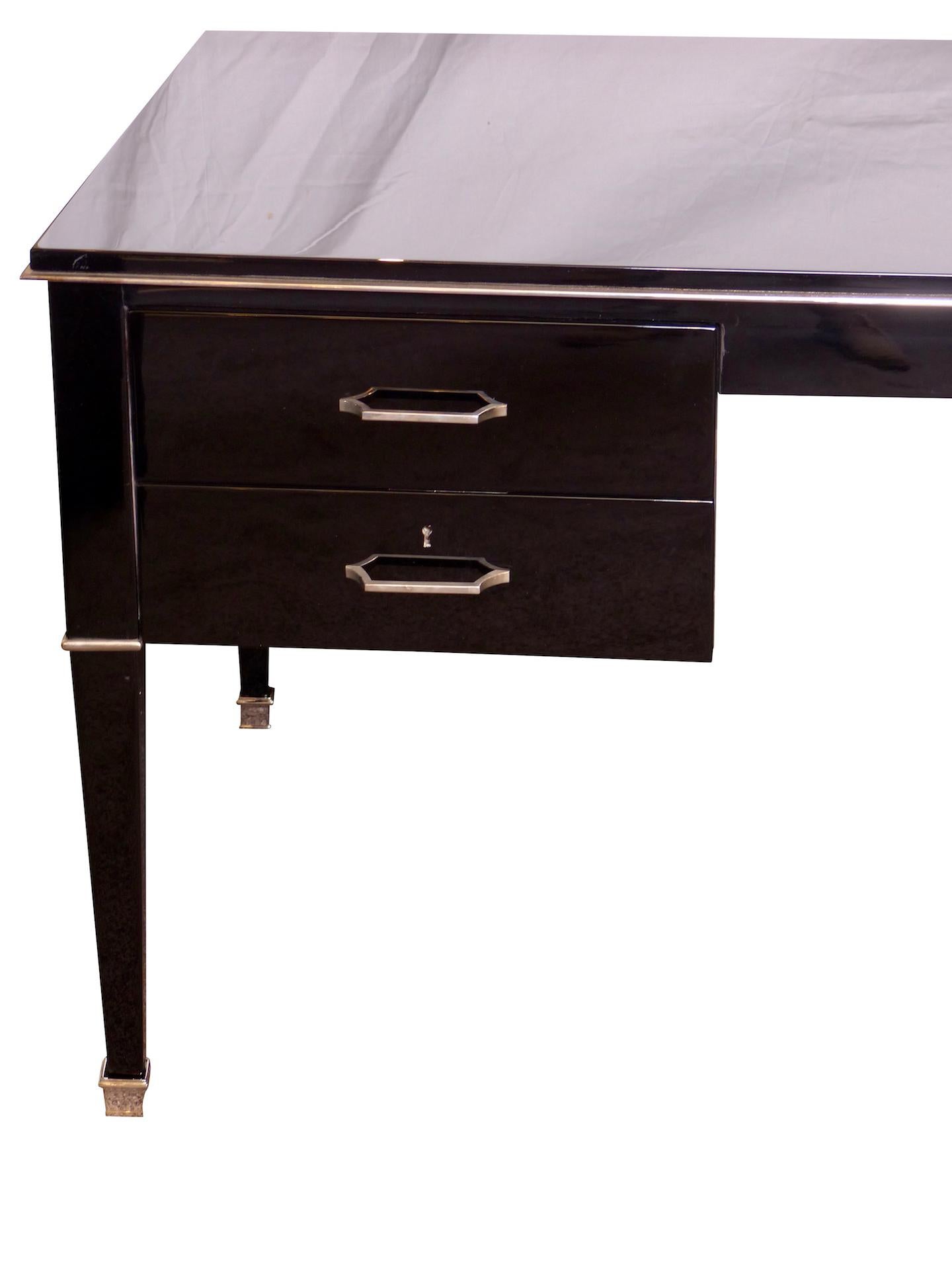 Original Belgian Art Deco desk by Decoene Frères.
High gloss black Piano lacquer.
Nickeled metal fittings and sabots.
All metals original.
Four drawers, two with key lock.
 