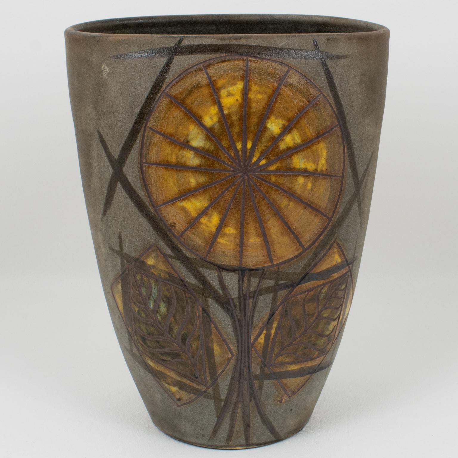 Alexandre Kostanda designed this fabulous Mid-Century modernist ceramic vase in this workshop in Vallauris, France, in the 1950s. The chunky oval shape has two unique hand-made floral motifs created from intricately scarred lines. The artwork