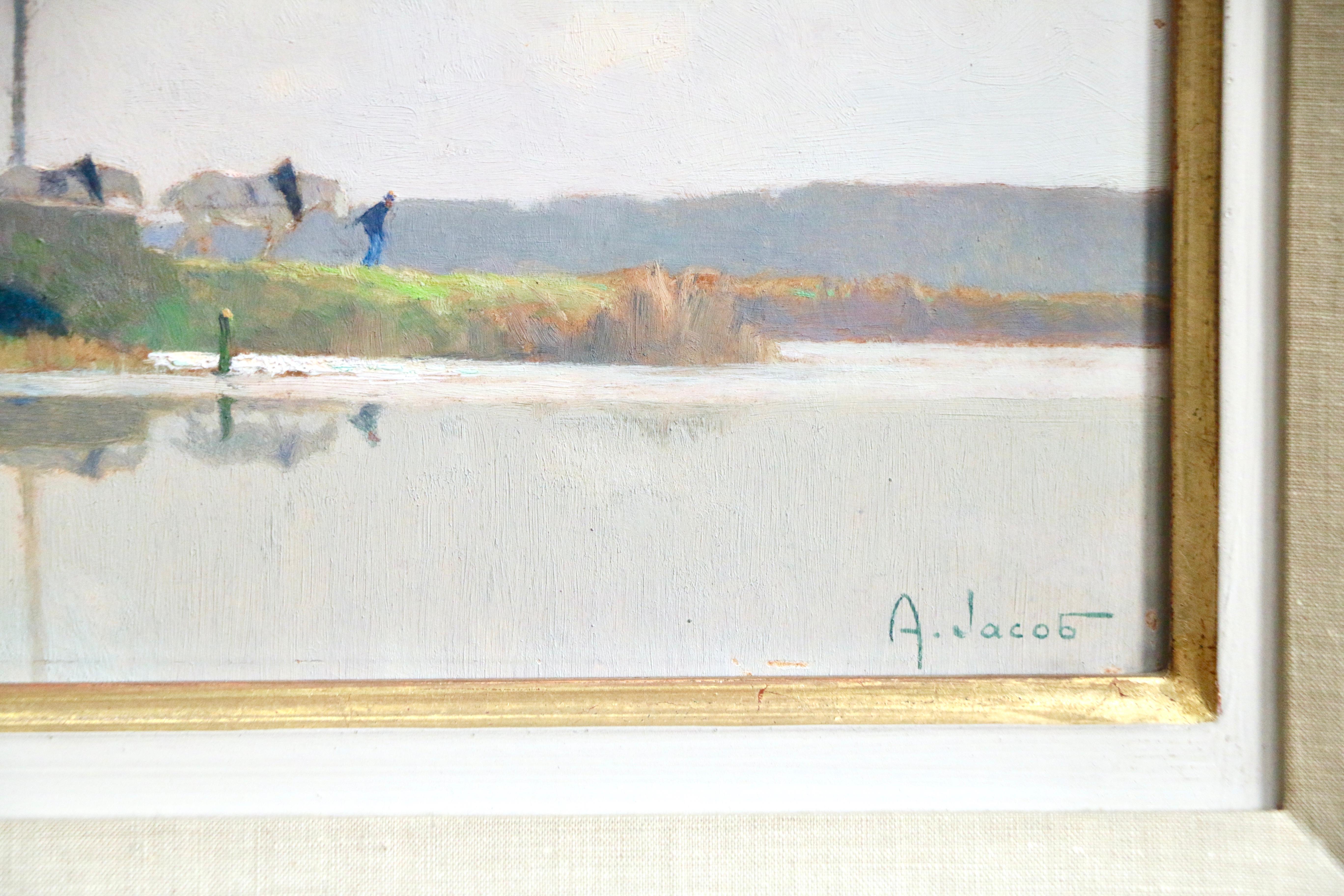 A picturesque image of a calm river with a gentlemen and horses walking by in the distance with the old mill in view. Oil on board by Alexandre Louis Jacob circa 1940. Signed lower right. Framed dimensions are 19 inches high by 22 inches