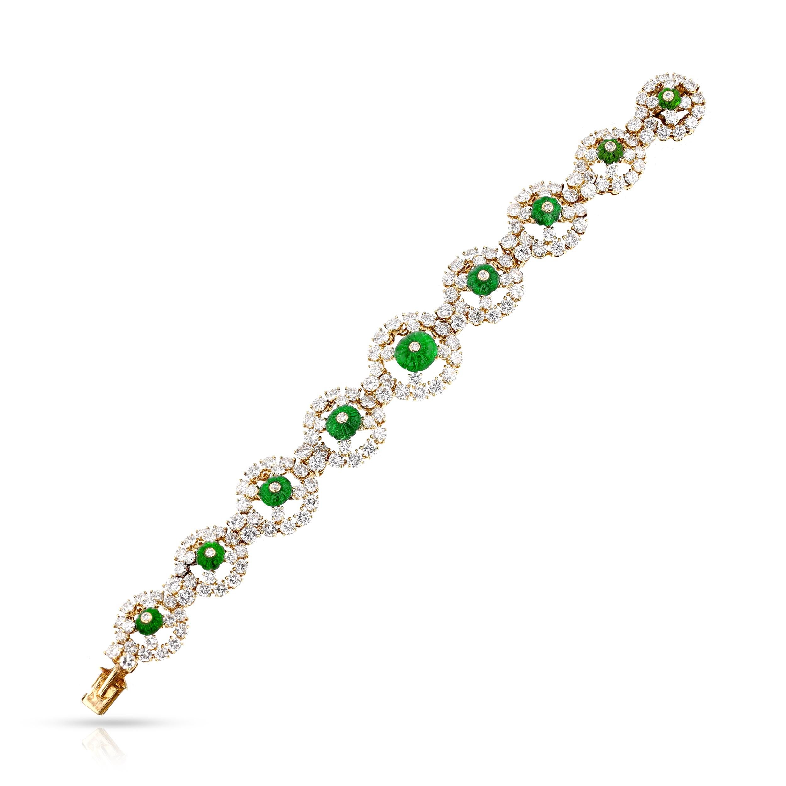 A beautiful Carved Emerald and Diamond Bracelet by Alexandre Reza. The bracelet has nine size-graduating round links, each set with a carved emerald in the center surrounded by brilliant-cut diamonds and round brilliant cut diamonds. The total