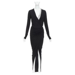 ALEXANDRE VAUTHIER - Robe cache-cœur noire, argentée et ornée d'un bijou en cristal.