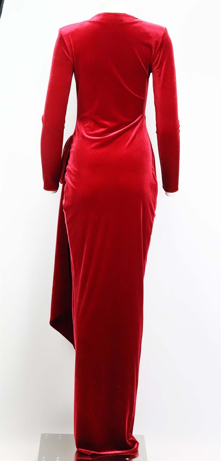 This gown by Alexandre Vauthier is cut from soft stretch-velvet and has a knotted, draped front that falls to an floor length, it has a plunging neckline and structured shoulders giving you that extra confidence. Red velvet. Concealed zip fastening