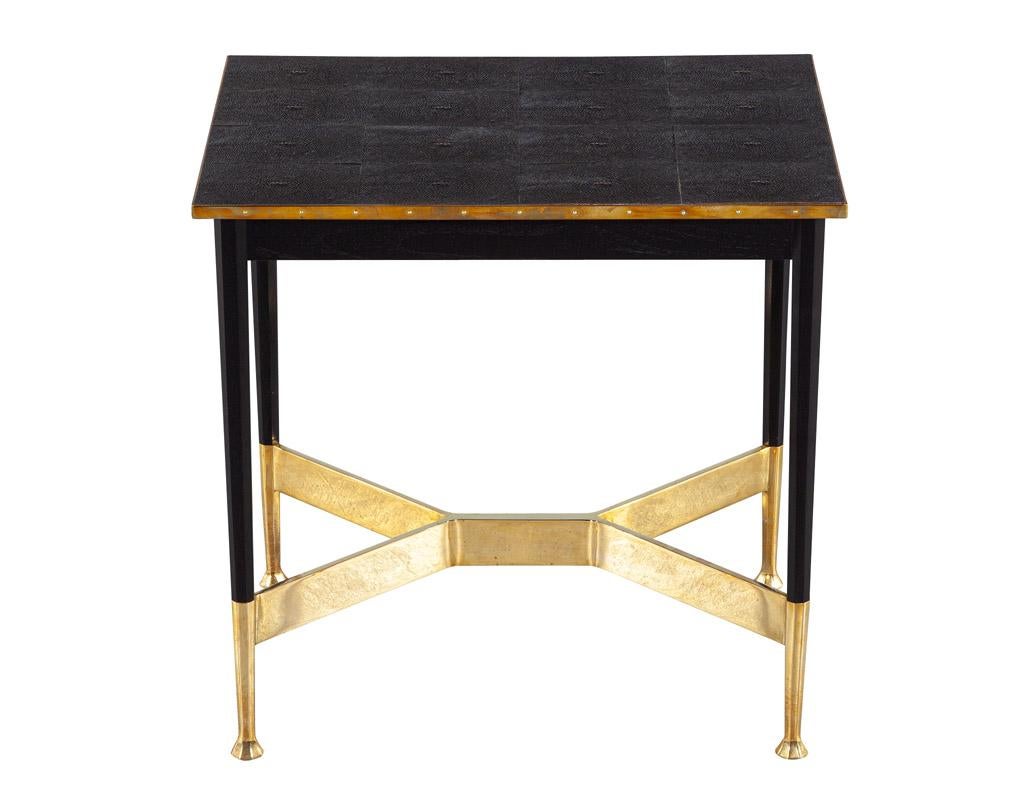 The Alexandria Salon Side Table, designed by iconic furniture maker Alexander Lamont, is an elegant and timeless piece of furniture. This side table features a unique brass pedestal frame with an aged patina look and is adorned with brass accents
