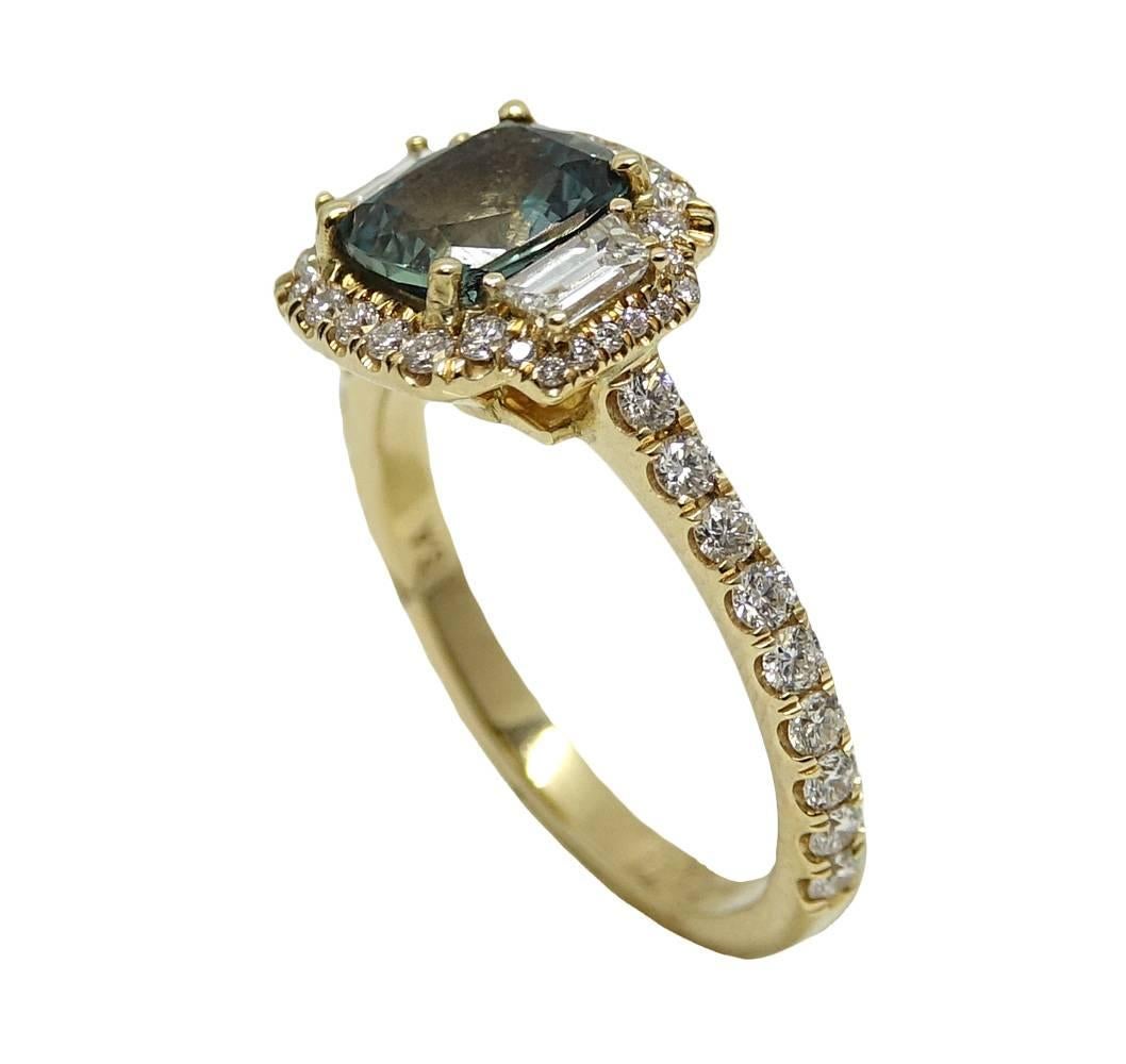 This Beautiful Ring Has A Center Cushion Cut Alexandrite  Weighing A Total Carat Weight Of 1.46 Carats. Two Trap Diamonds Are Set Along The Alexandrite and Round Diamonds Are Set Along The Halo and Shank Weighing A Total Carat Weight Of 0.82 Carats.