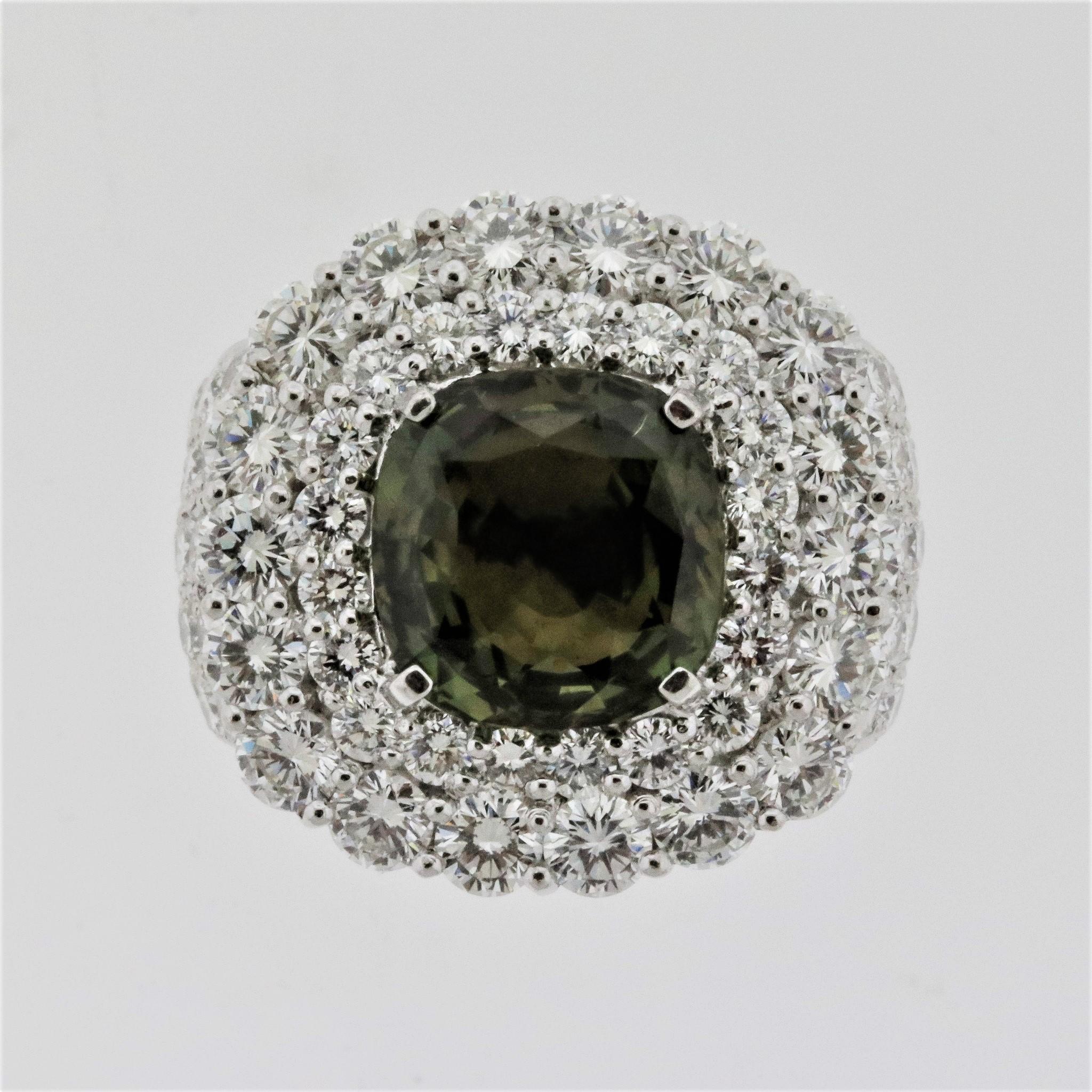 A sexy ring featuring a 4.43 carat natural alexandrite and a blanket of bright white diamonds. The alexandrite is a cushion-shape and has great color-change as it moves from white to yellow light. The diamonds weigh 4.30 carats and are set around