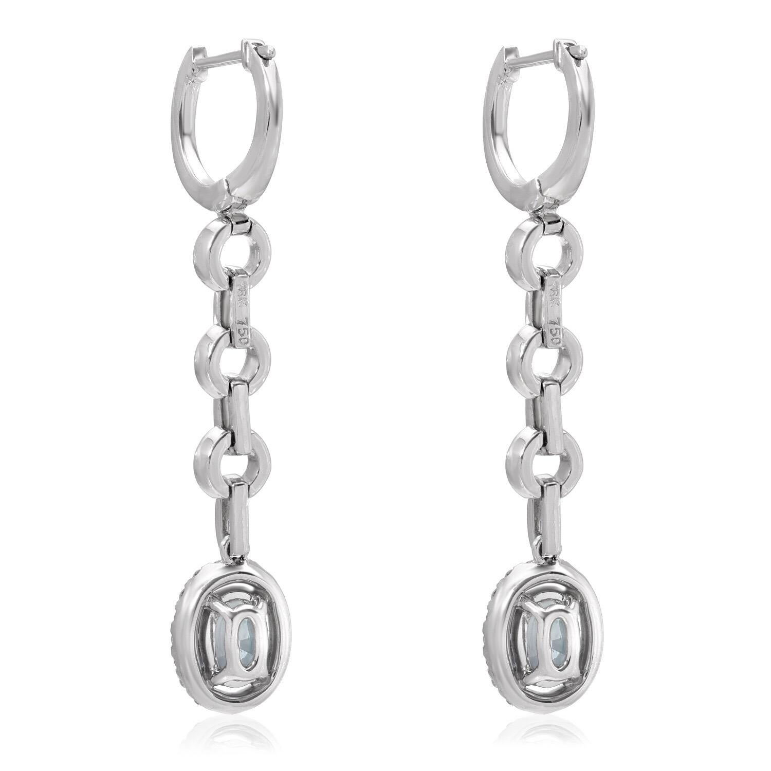 Rare pair of oval Alexandrites, weighing a total of 1.12 carats, are surrounded by a total of 0.45 carats of round brilliant diamonds, in these lever back, drop, 18K white gold diamond earrings, for women.

GIA certificates are attached to the