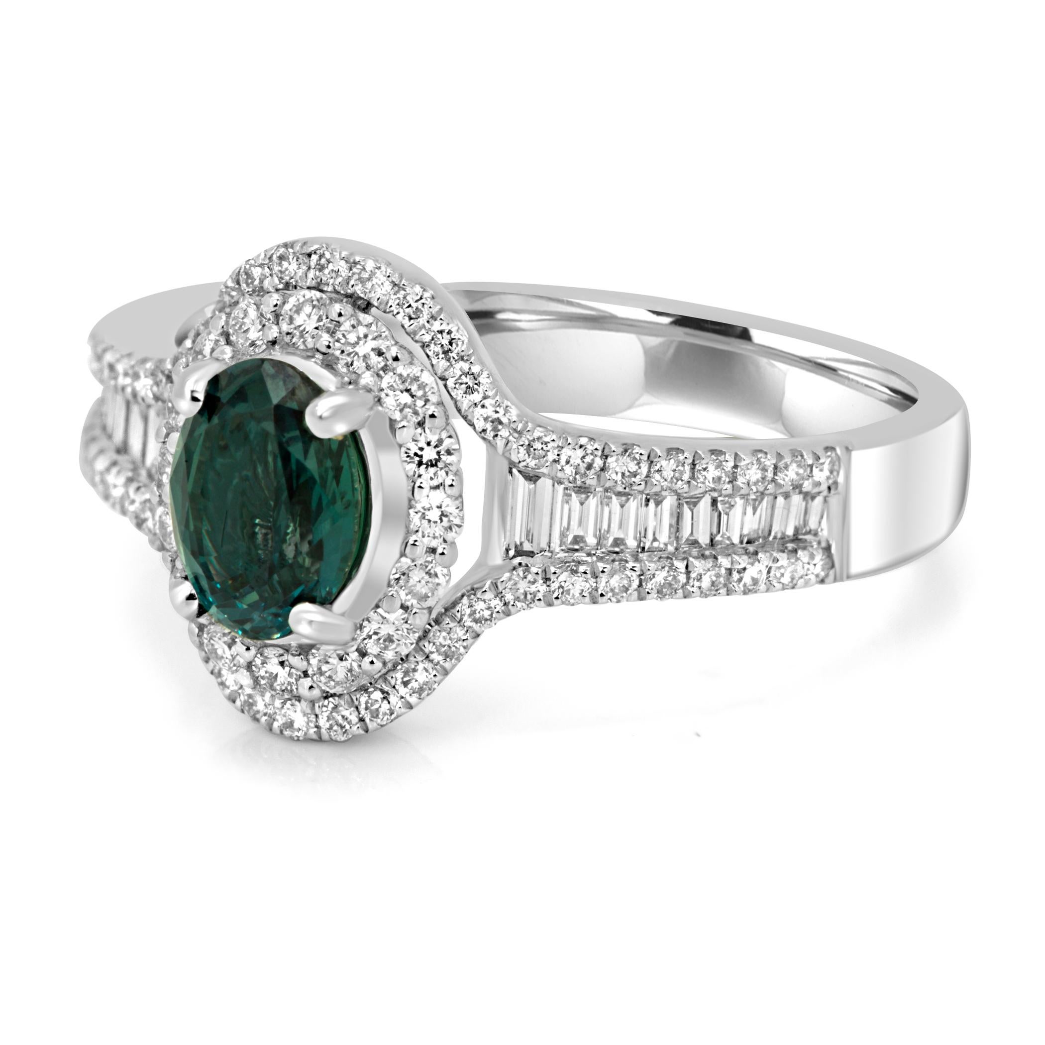 At the heart of this exquisite ring lies a captivating Alexandrite Oval, meticulously chosen for its impressive size and its remarkable color-changing properties. With a weight of 0.76 carats, this Alexandrite's magnificent lush green hues creates