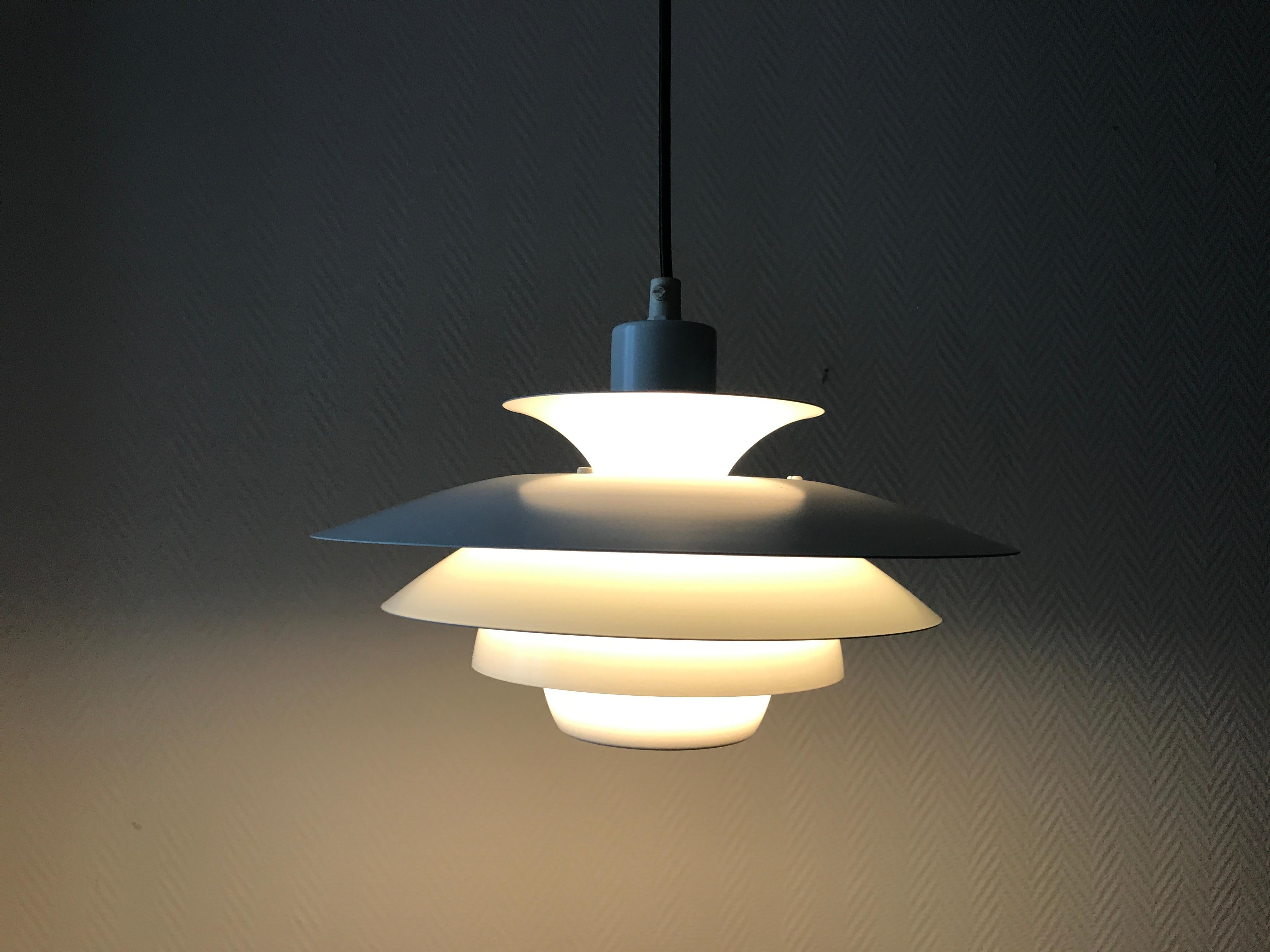 Alexia Danish vintage pendant white pendant is made of five metal shade, layered with a small distance to each other creating a very soft illumination. Almost a weightless appearance. Each of the five shades are featured with inner coating in white