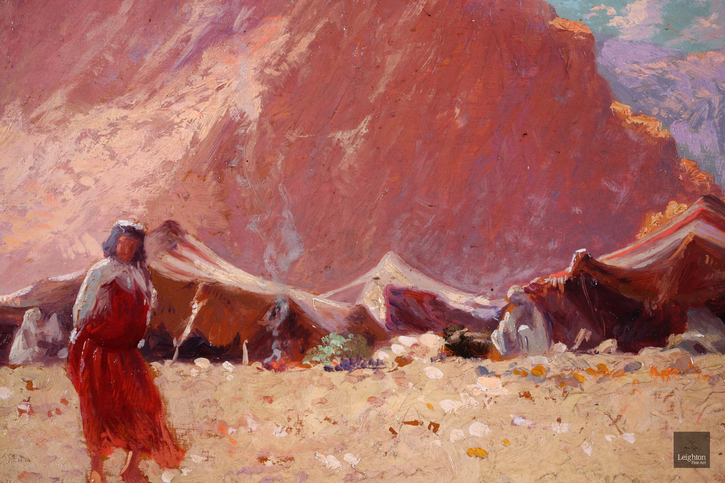 Signed and dated orientalist figurative landscape oil by French painter Alexis Auguste Delahogue. The work depicts the camp of Bedouin - a nomadic Arb tribe - in an arid desert of Algeria. Many figures can be seen crouching under tents and in the