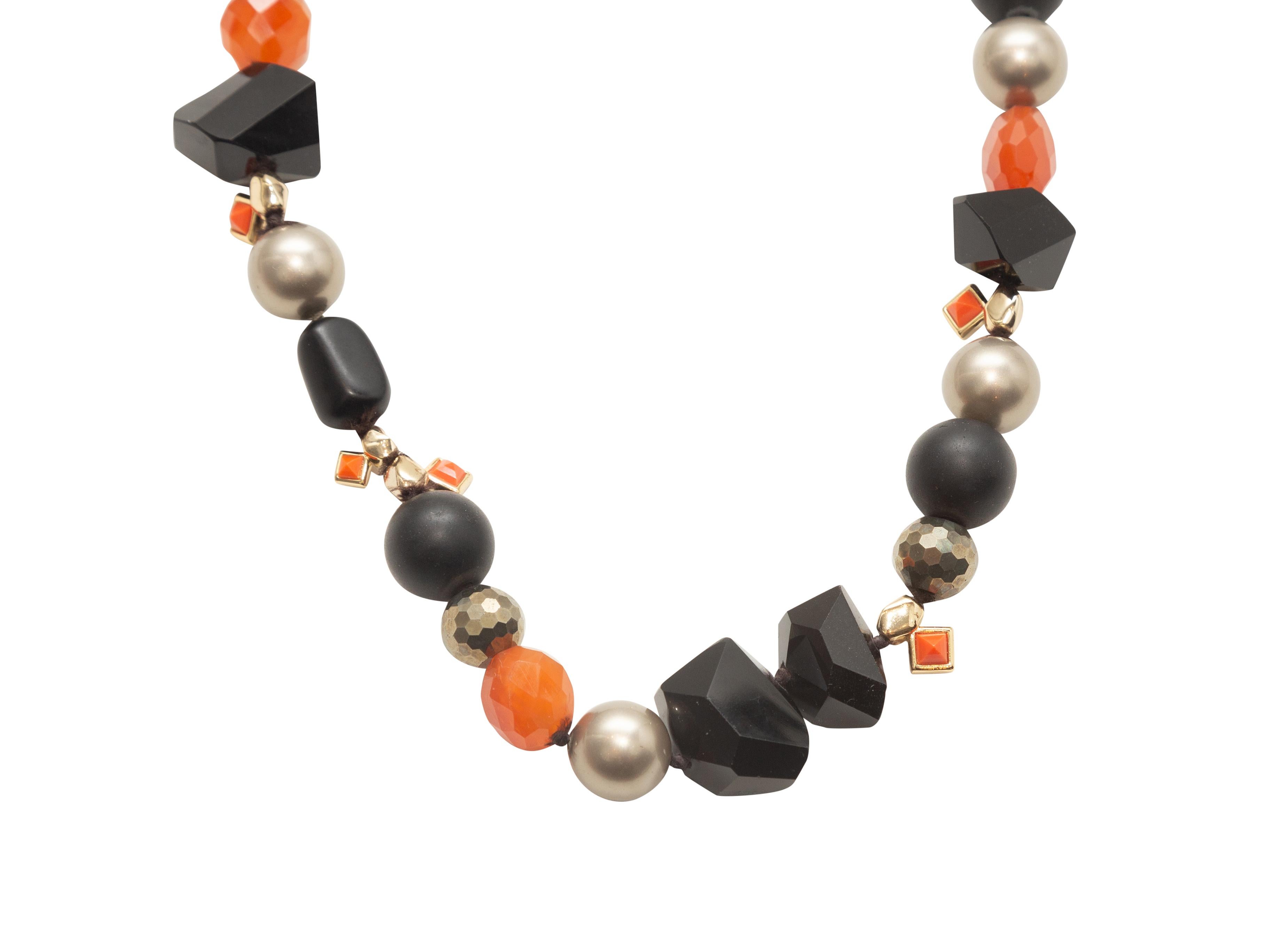 Product details: Black, orange, and gold beaded necklace by Alexis Bittar. Lobster claw closure. 20.5