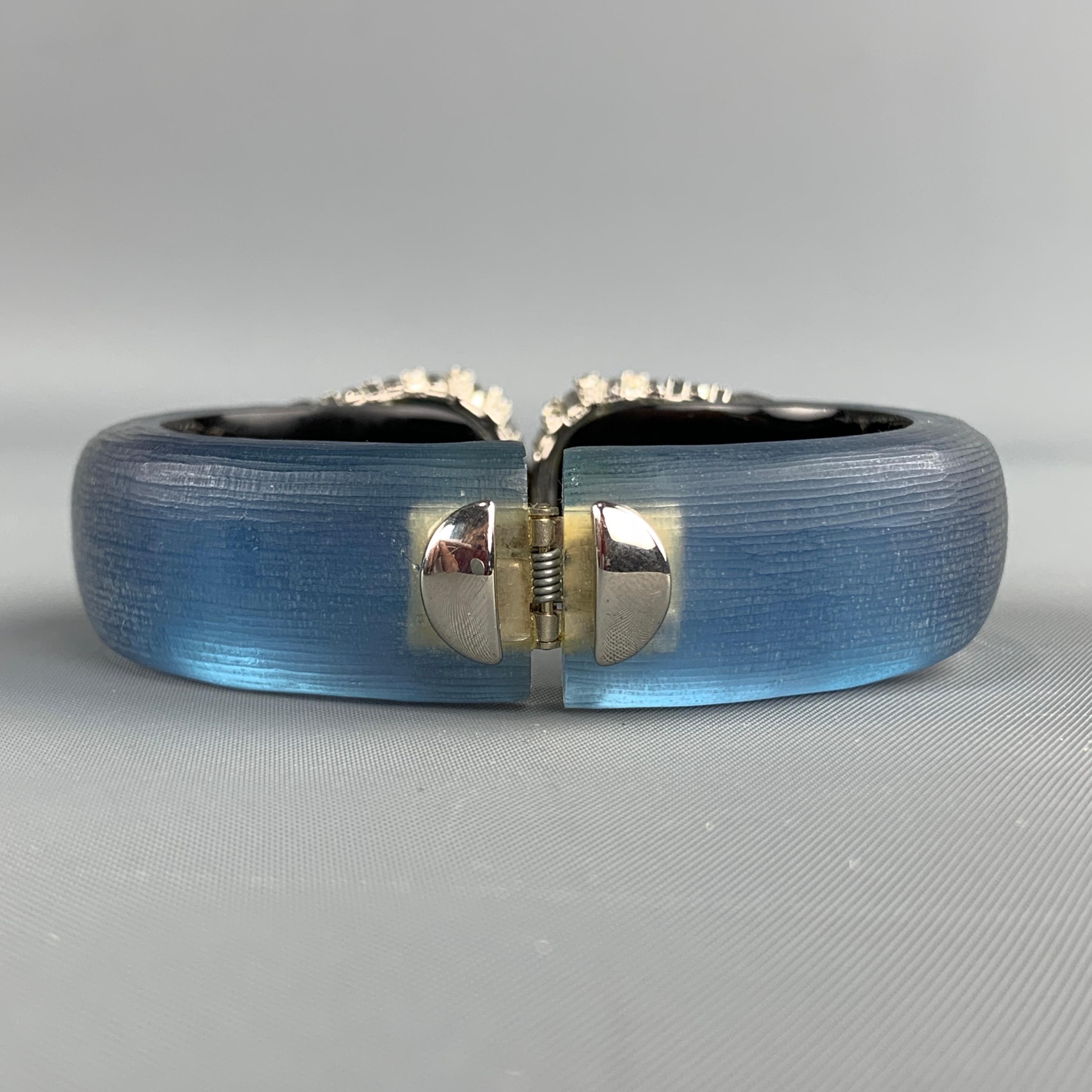 ALEXIS BITTAR Bracelet comes in a blue tone in a lucite material, with a silver tone metal hardware, rhinestones, crystals and a magnetic closure.
 
Excellent Pre-Owned Condition.
Fits: 7 in.