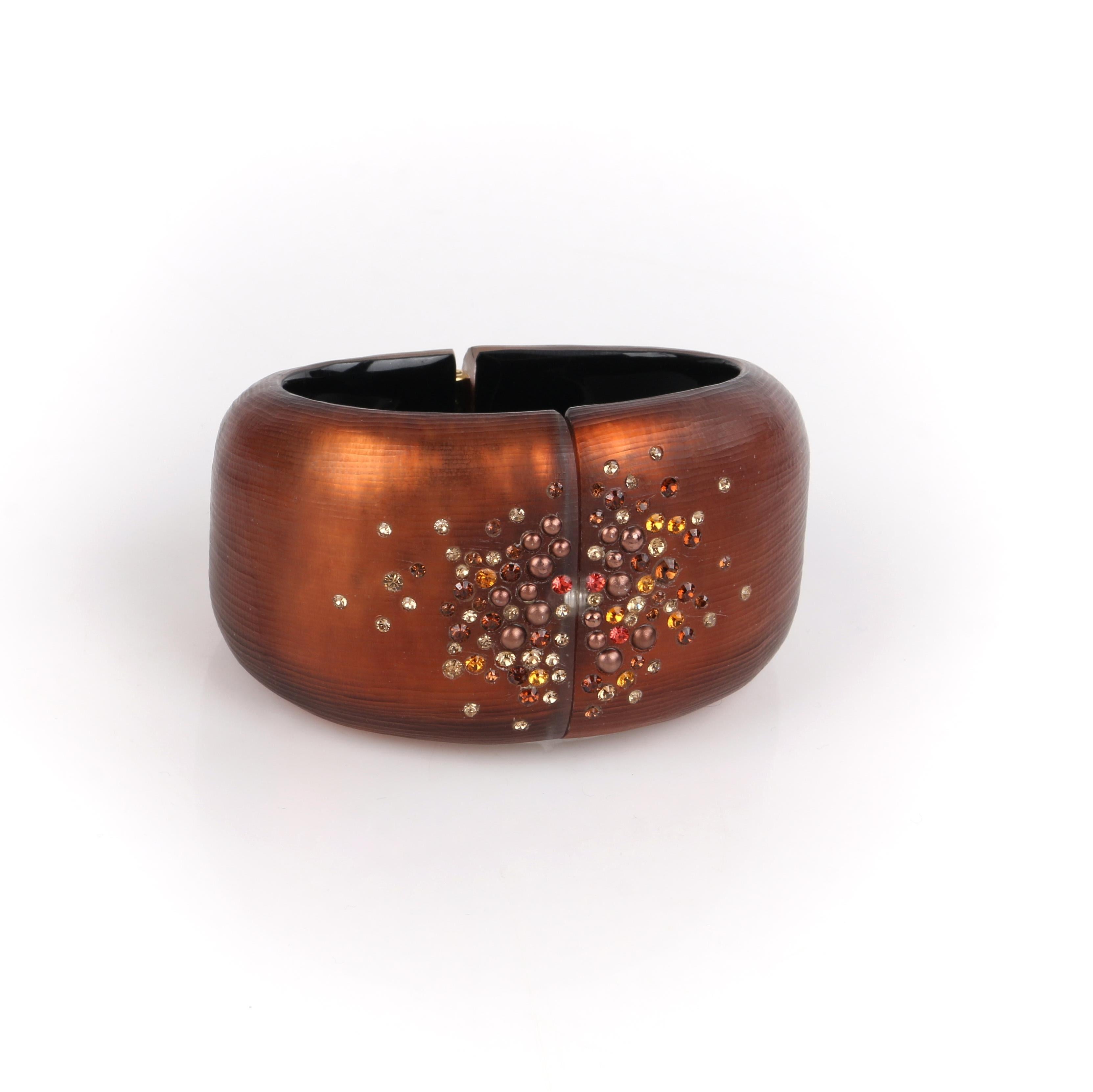 ALEXIS BITTAR Brown Plated 10K Gold Crystal Lucite Clamper Statement Bracelet 

Brand / Manufacturer: Alexis Bittar 
Style: Bangle, bracelet
Color(s): Shades of brown, orange, red, black and gold. 
Unmarked Material: Lucite and 10K gold. 
Additional