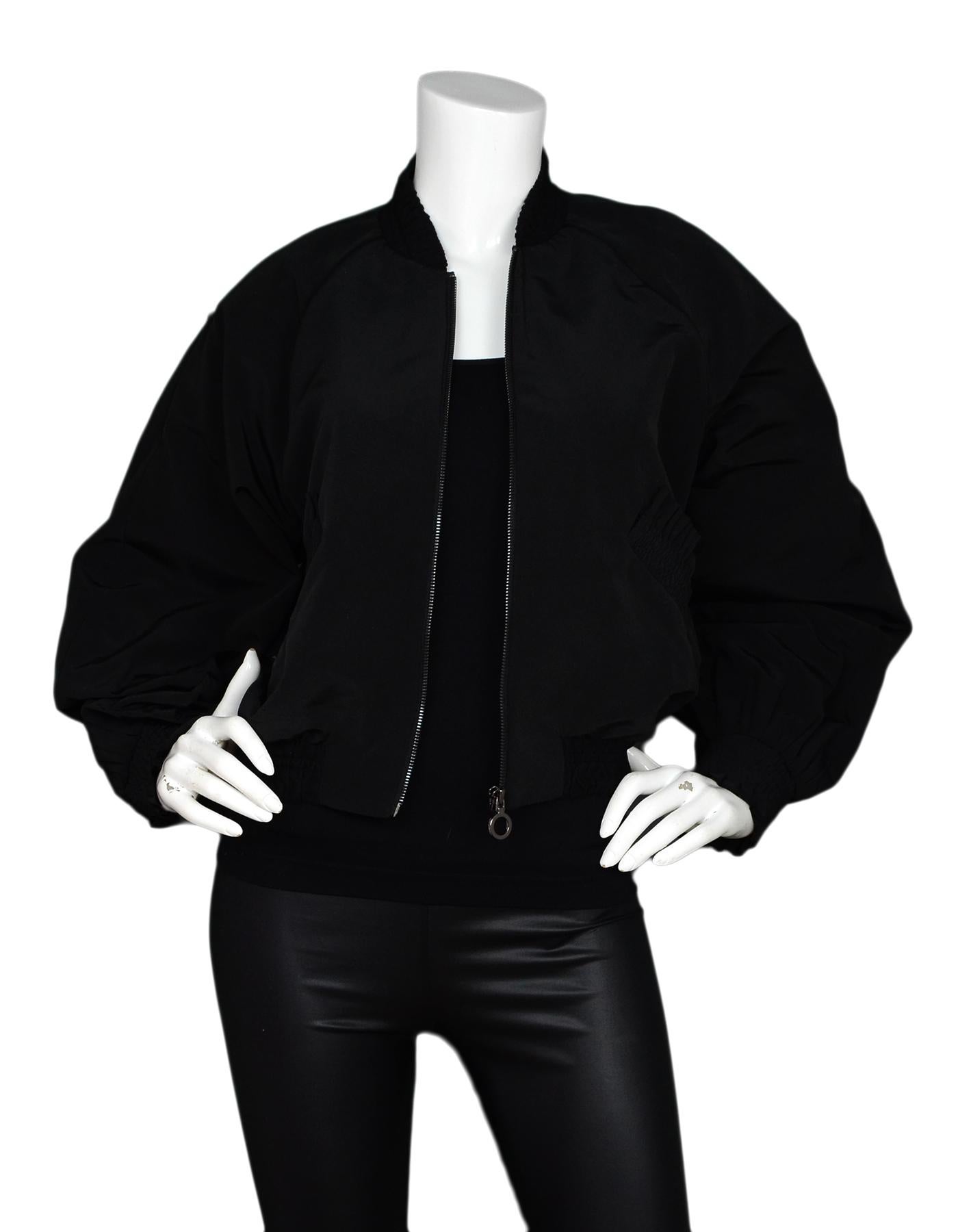 Alexis Black Bomber Jacket W/ Ruffle Pockets Sz S

Made In: China
Color: Black
Materials: 100% polyester
Opening/Closure: Gunmetal front zipper
Overall Condition: Excellent pre-owned condition 

Measurements: 
Shoulder To Shoulder: 20