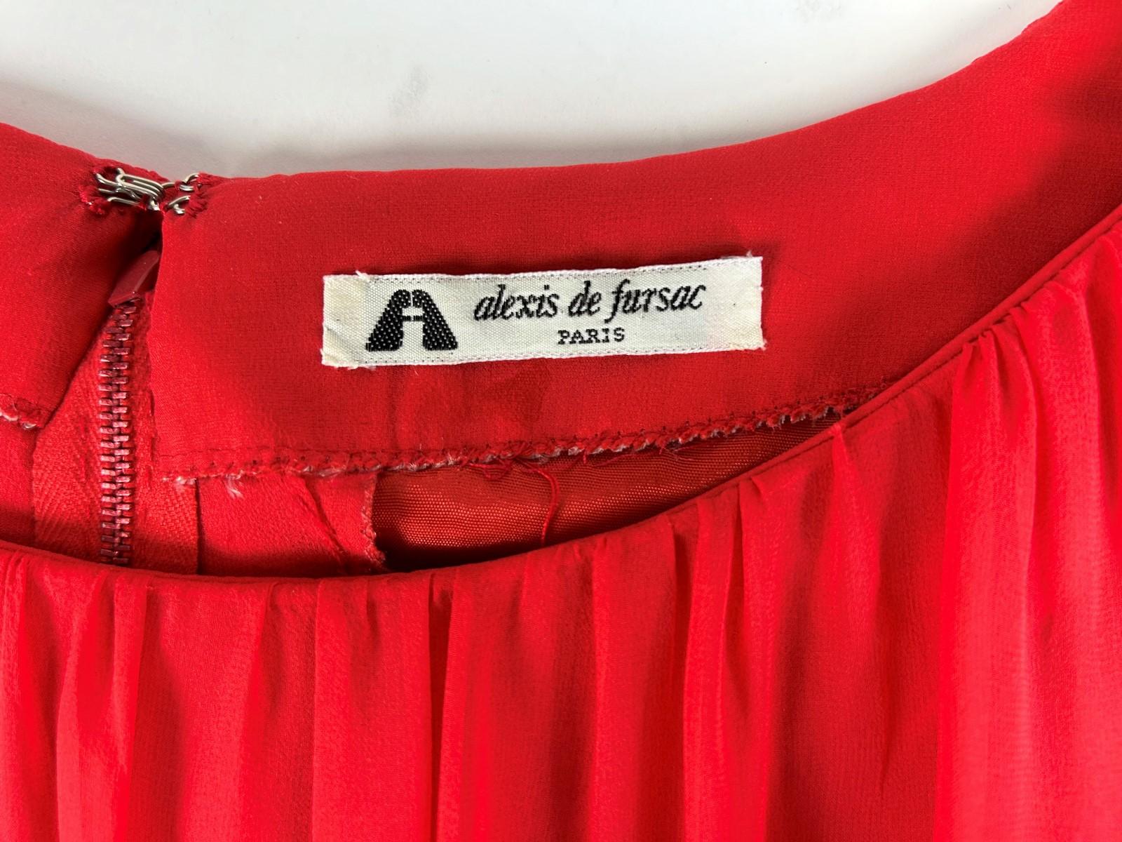 Circa 1990

France

Majestic evening or formal long dress in scarlet silk chiffon by Maison Alexis de Fursac in Paris from the 1990s. Pleated boat neckline at the bust, long sleeves buttoned at the cuffs and a large built-in cape that ends in a