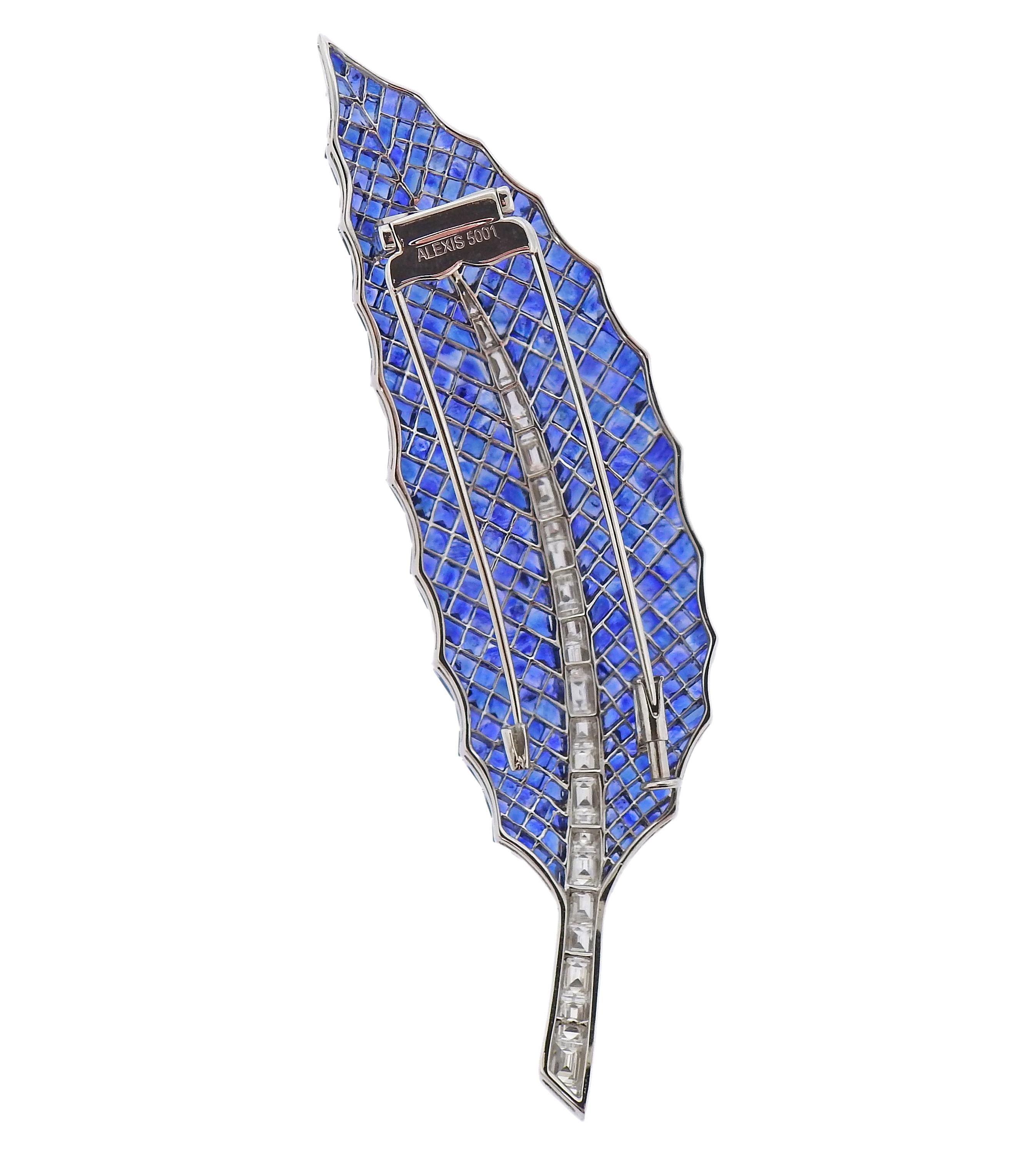 Exquisite 18k gold feather brooch by Alexis, with approx. 38-40cts in blue invisible set sapphires and 2.06ctw in diamonds. Brooch measures 3.75