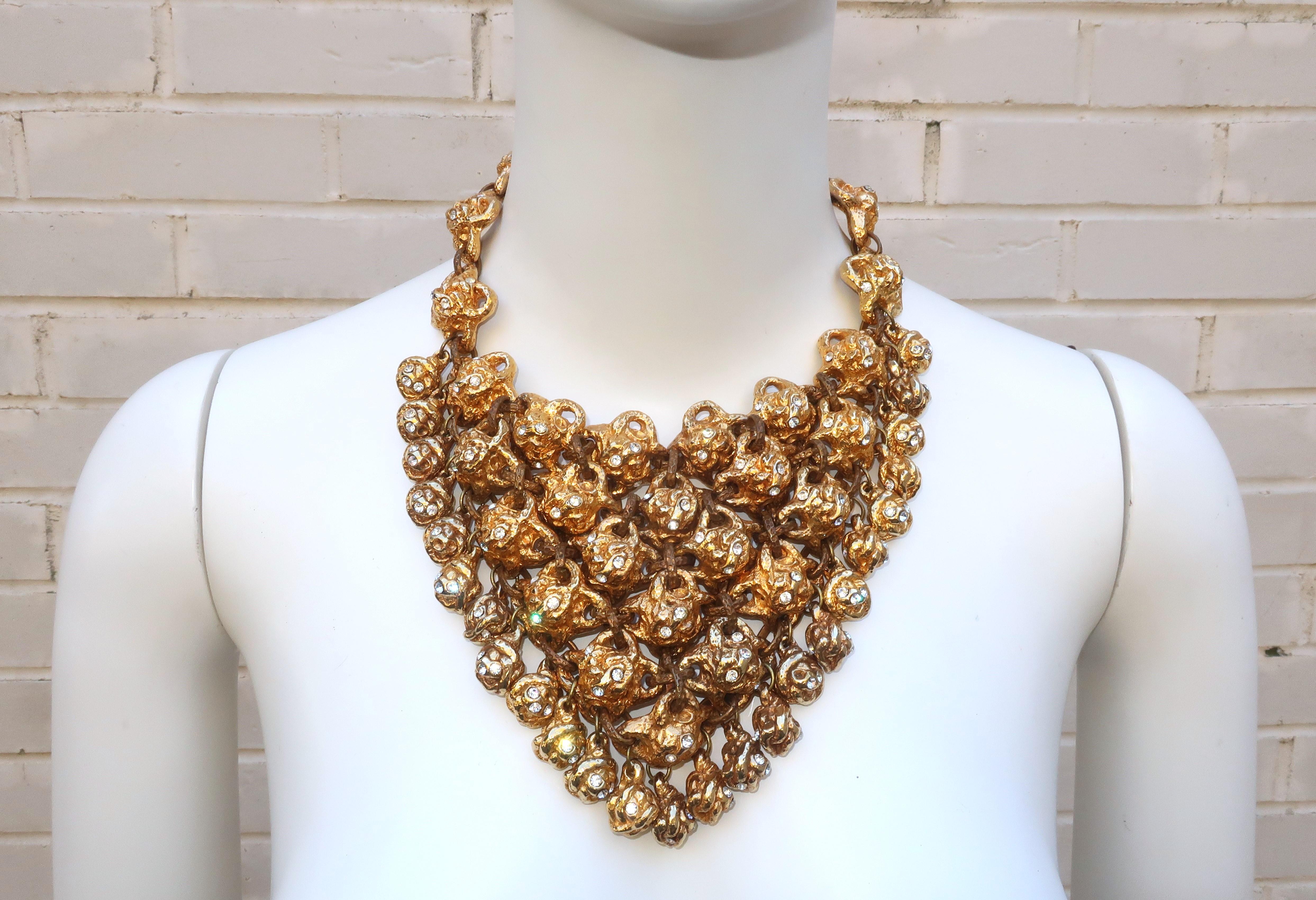 Fabulous 1980’s Alexis Lahellac brutalist bib necklace with the statement making look of chunky gold nuggets accented by sparkling crystal rhinestones.  The necklace is created by linking rows of nugget-like gold tone metal alloy charms with
