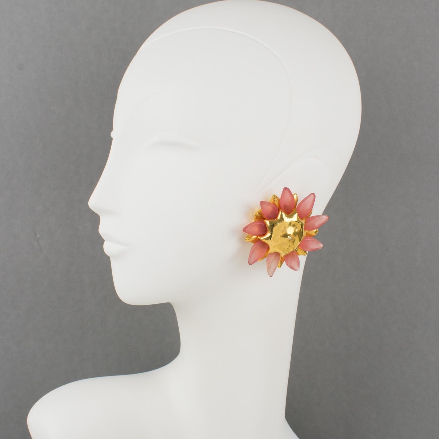 These exquisite Alexis Lahellec Paris resin clip-on earrings feature a flower-shaped gilt metal-coated resin framing topped with powder pink flower petals. Each piece is signed on the underside with the brand logo and under fastenings: 