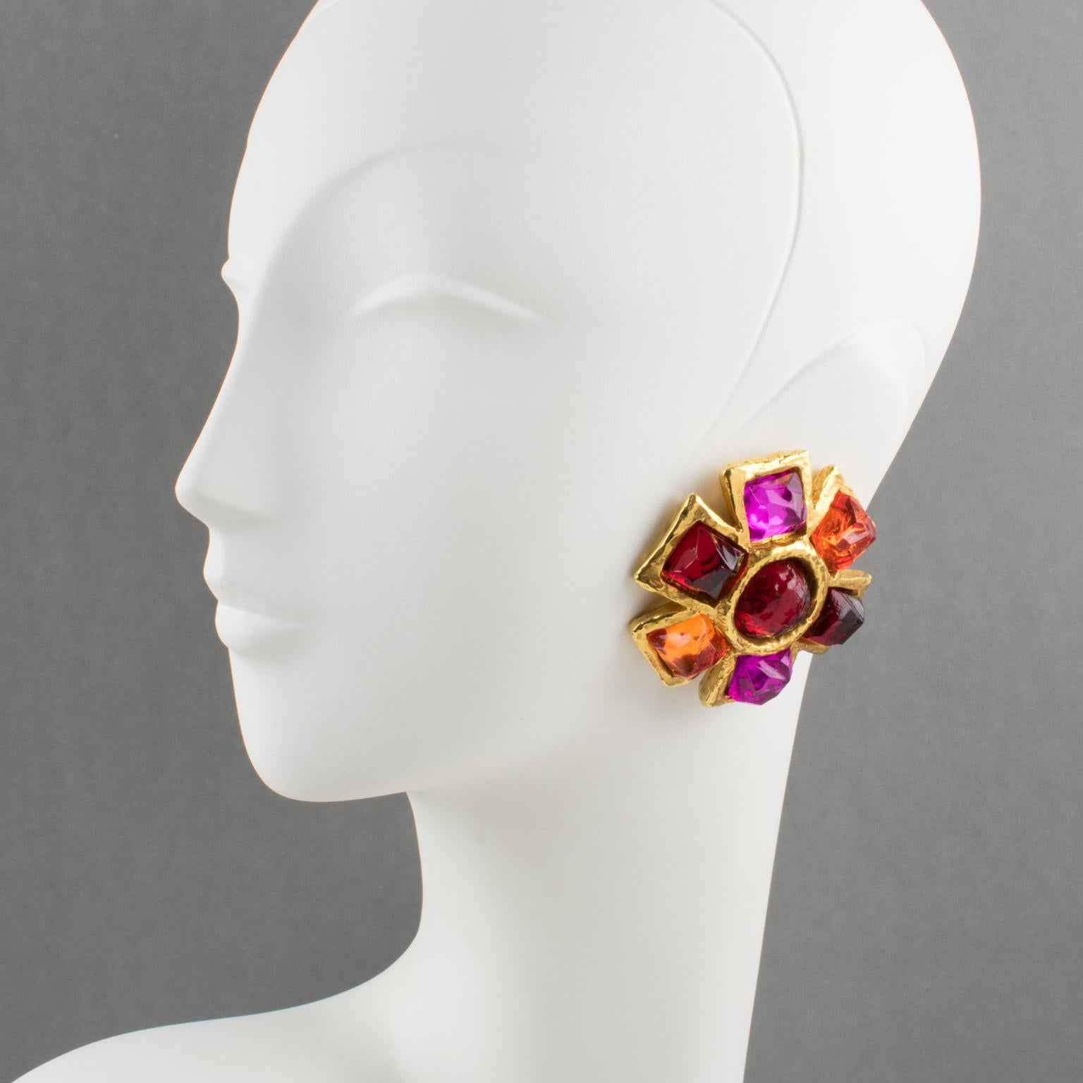 Exquisite Alexis Lahellec Paris signed clip-on earrings. A couture piece from that famous French Jewelry designer, featuring star-shaped gilt metal-coated resin elements topped with colorful resin cabochons. Assorted tones of ruby red, fuchsia pink,