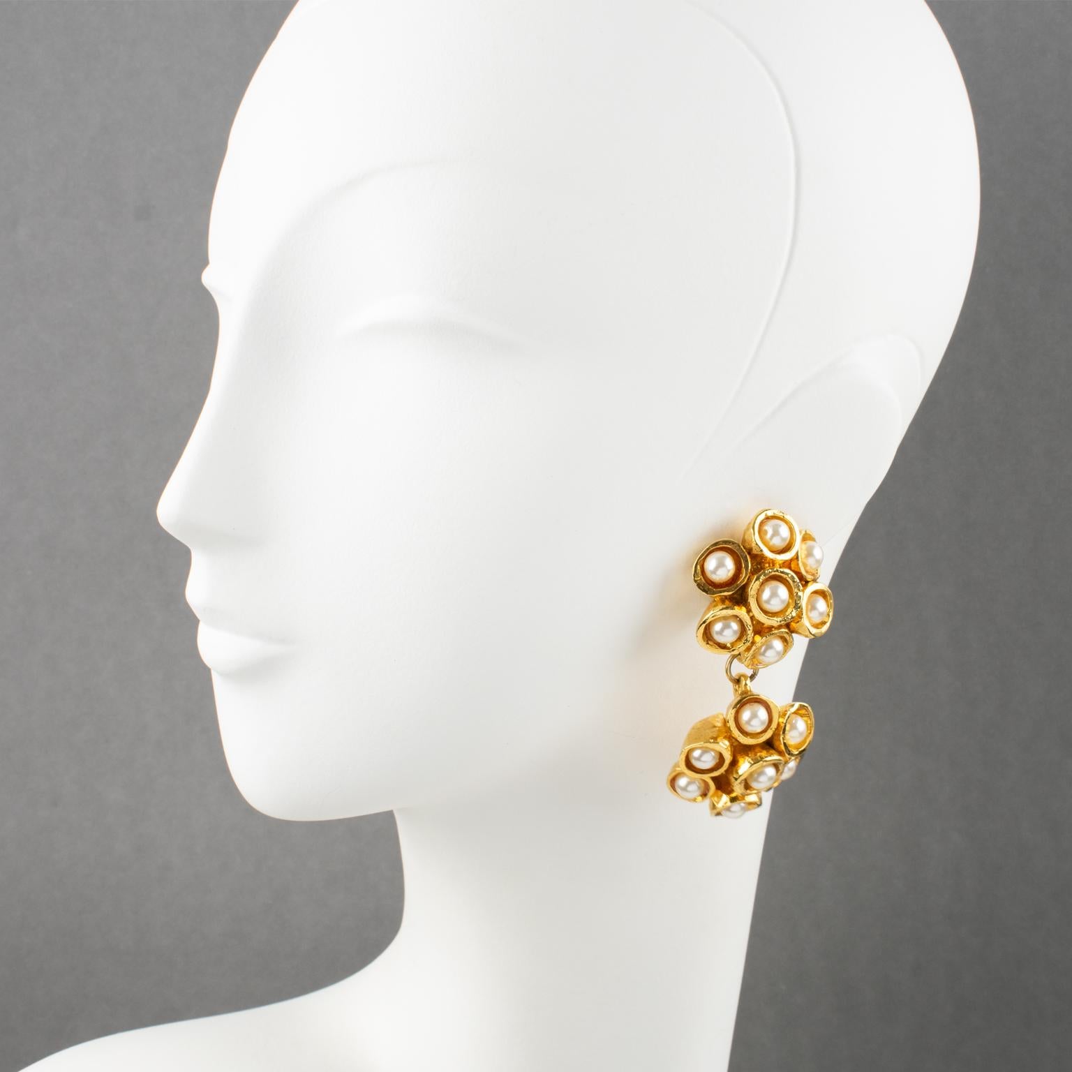 Lovely French designer Alexis Lahellec Paris dangling clip-on earrings. They feature an oversized floral design with gilt metal-coated resin framing, all textured and topped with pearl imitation beads. Signed at the back: 