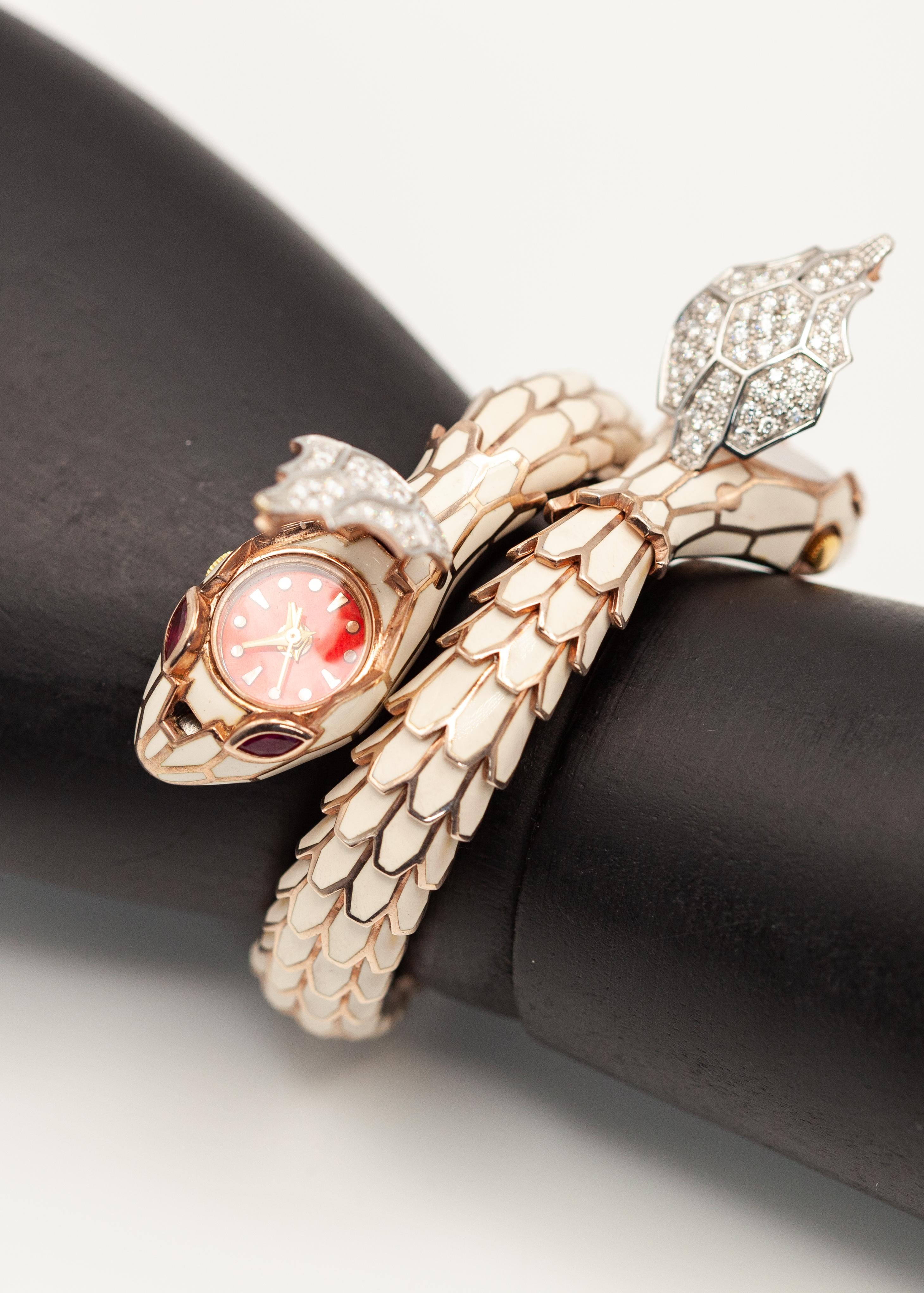 This fabulous Alexis NY 18K and sterling diamond ruby white enamel snake wrap bracelet watch crafted in 18K rose gold and sterling silver rose gold vermeil set with 110 brilliant cut diamonds approximate 1.45 carats in G color VS-SI clarity and 4