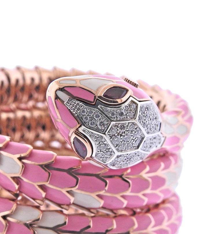 Large 18k rose gold and sterling silver snake wrap bracelet, decorated with pink and white enamel, 1.10ctw in H/VS-Si1 diamonds and 0.56ctw rubies. Bracelet will fit approx. 6.5-7