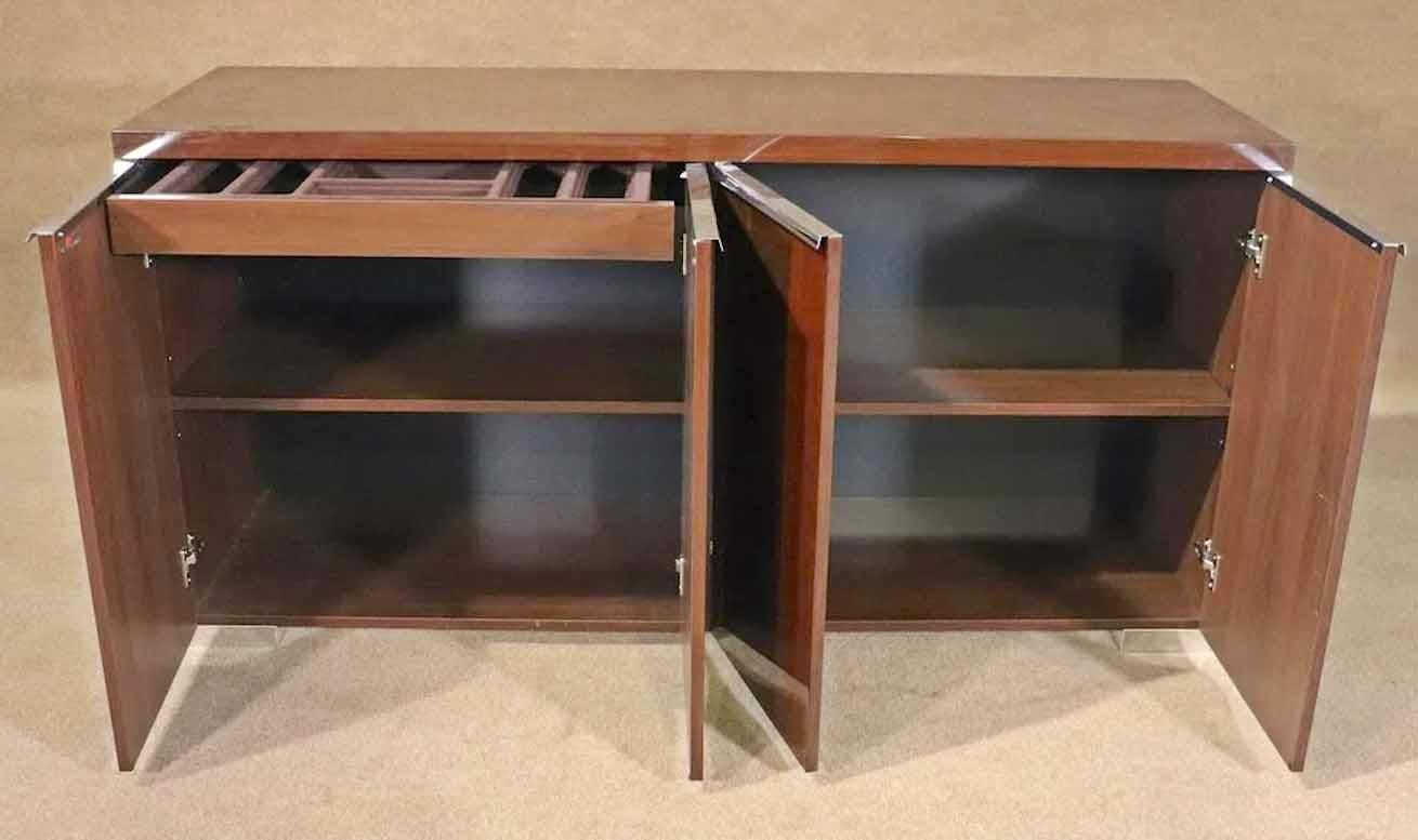 Gorgeous laquered cabinet with polished chrome accents. Master craftsmanship brings multiple wood grain inlays to make a great modern design. Made by Alf Group in Italy for their Pisa Collection.
Please confirm location.