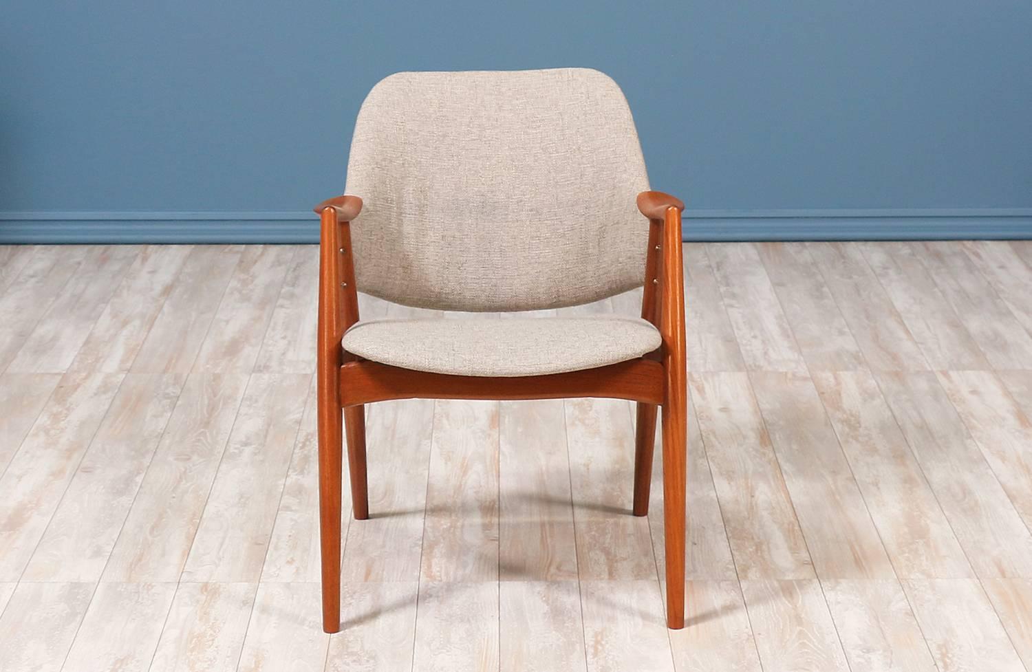 Swedish Modern “Kontur” armchair designed by Alf Svensson for Dux of Sweden in the 1950’s. This armchair features a teak wood frame with clean lines and tapered, angled legs. The seat and backrest have been upholstered in a muted grey soft tweed