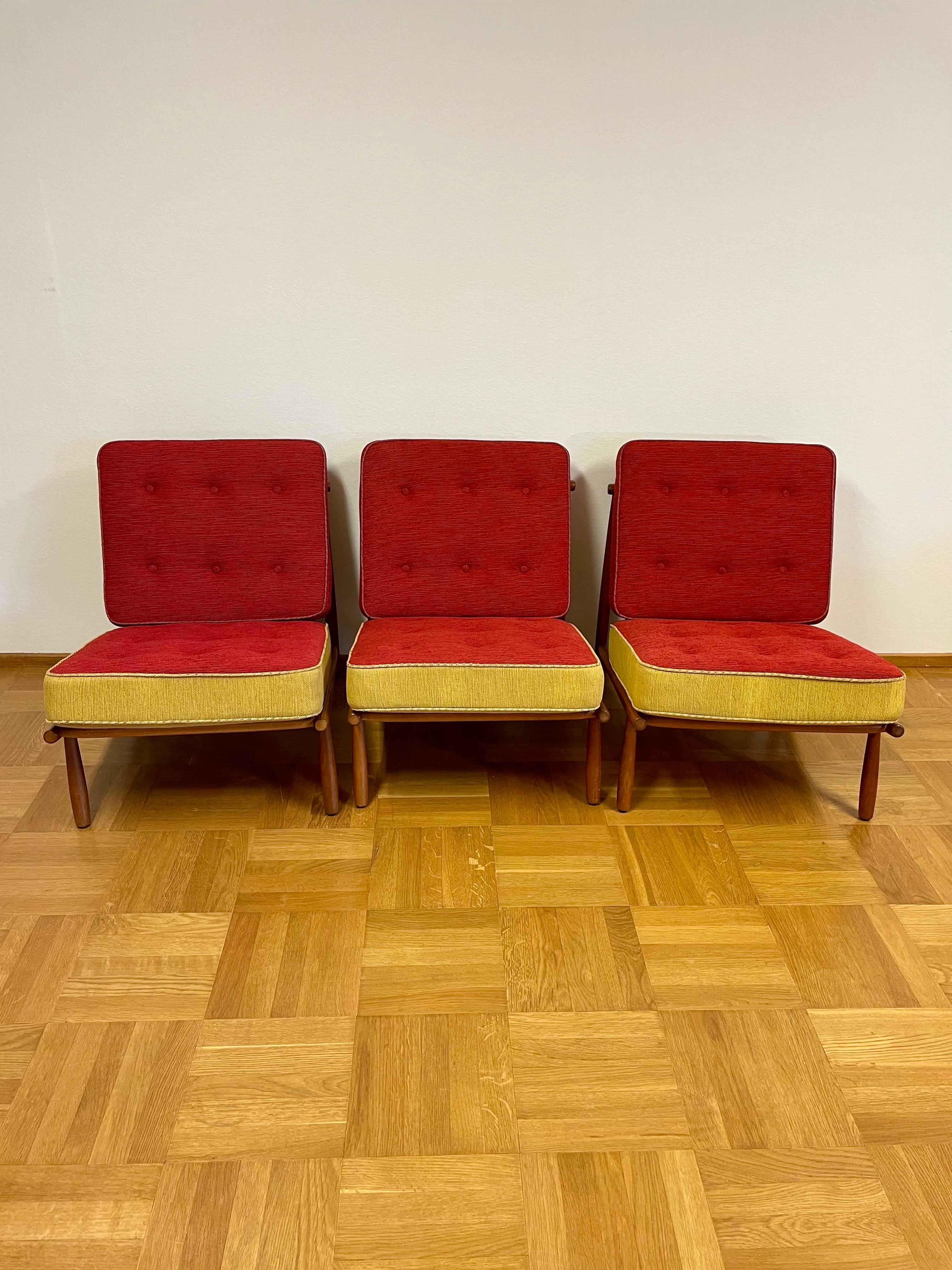 This is the Alf Svensson, 3 Domus easy chair set from Dux.
It comes with three easy chairs in mahogany stained beech, loose cushions with spring core and wool fabric. 

This chair, today a really cool sought-after retro model, was designed in 1955