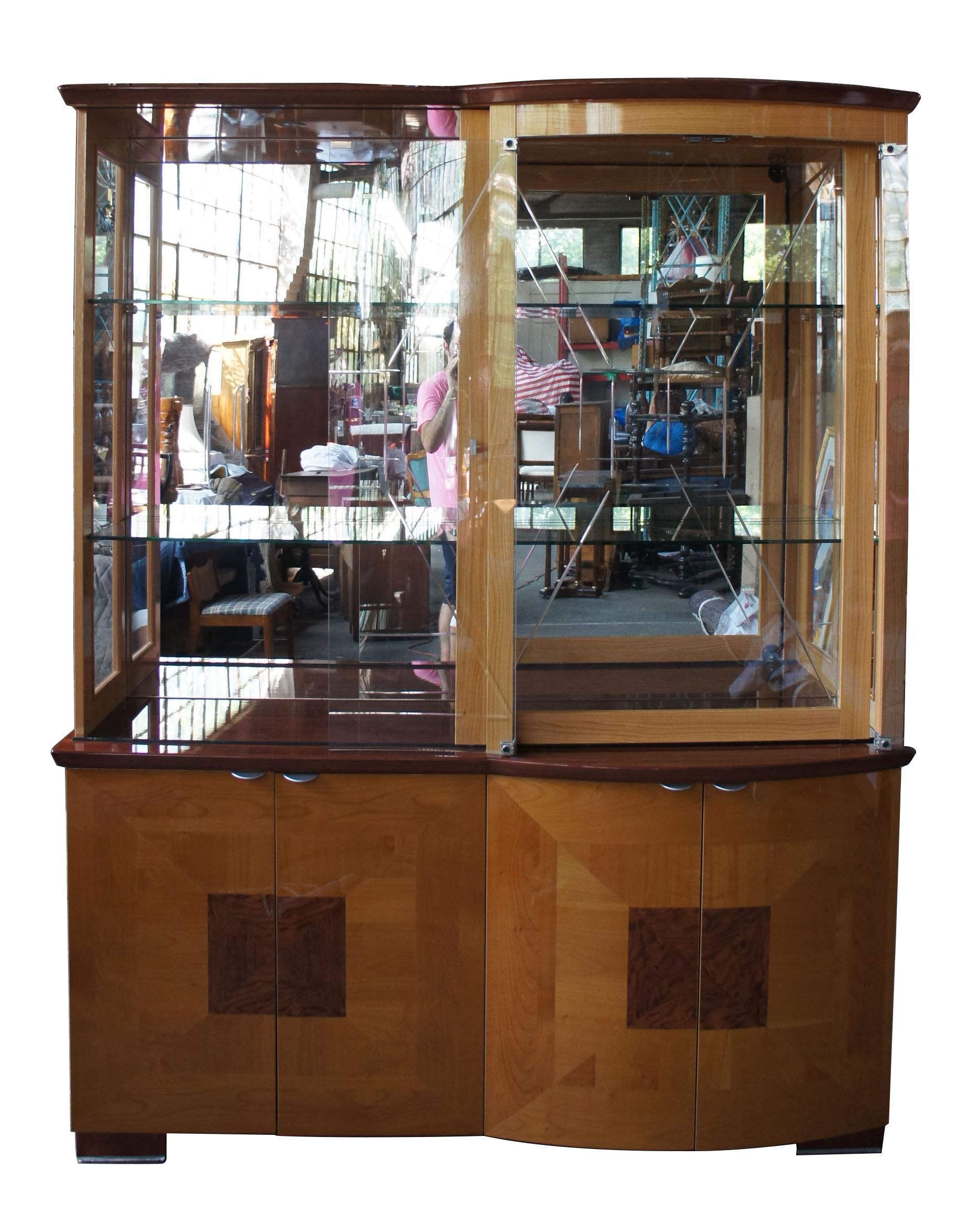 Alf Uno Italian modern walnut china hutch illuminated curio cabinet vitrine MCM

A gorgeous cabinet that can be used for display in any setting. Made from maple and walnut with a lacquered high-gloss finish. An illuminated top with mirrored