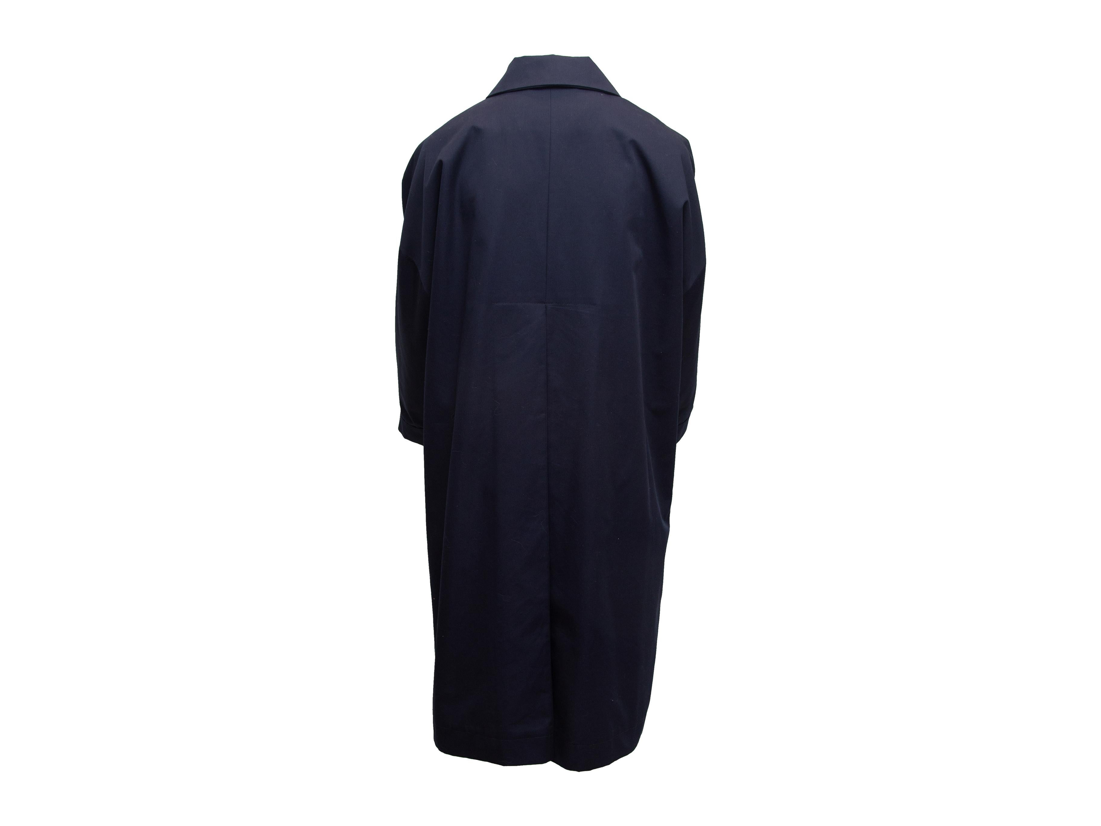 Product details: Navy long coat by Alfa Perro. Pointed collar. Button and tie closures at front. 44