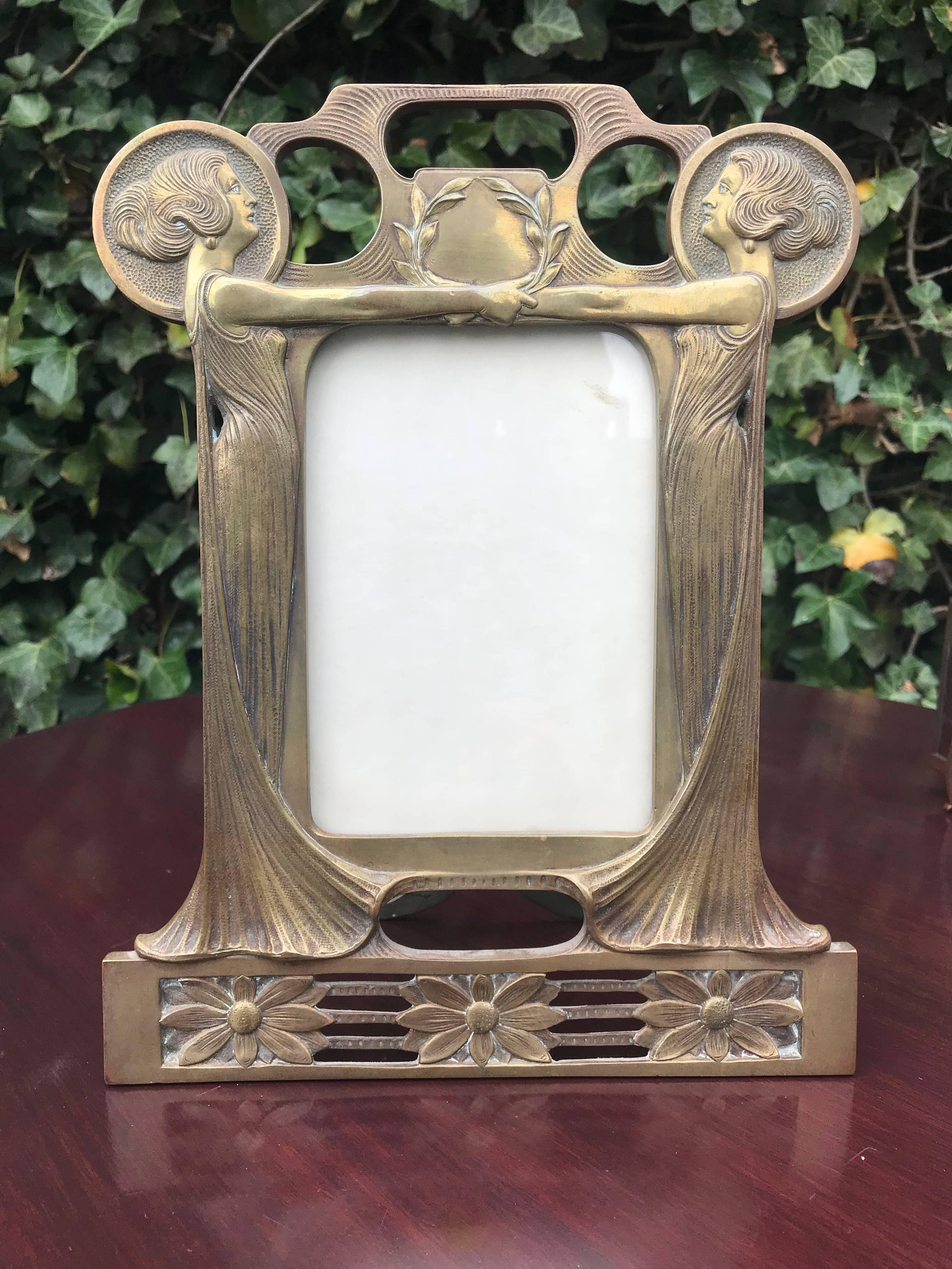 Gorgeous, meaningful and decorative fine art picture frame.

This early 1900s Art Nouveau picture frame in the style of Alfons Mucha is a wonderful sight to see. Incorporated in this handcrafted frame are two stunning Art Nouveau ladies who,