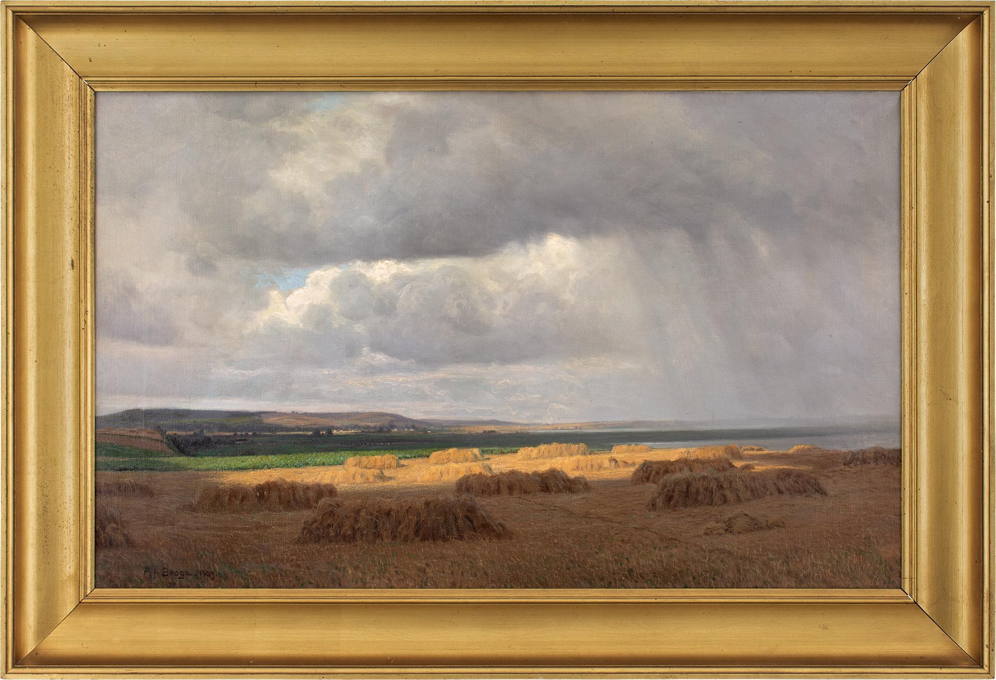 This early 20th-century oil painting by Danish artist Alfred Broge (1870-1955) depicts a rural coastal landscape with hayfield, crops, and distant hills. It’s a masterful work, with the light carefully observed as it breaks through a gap in the rain