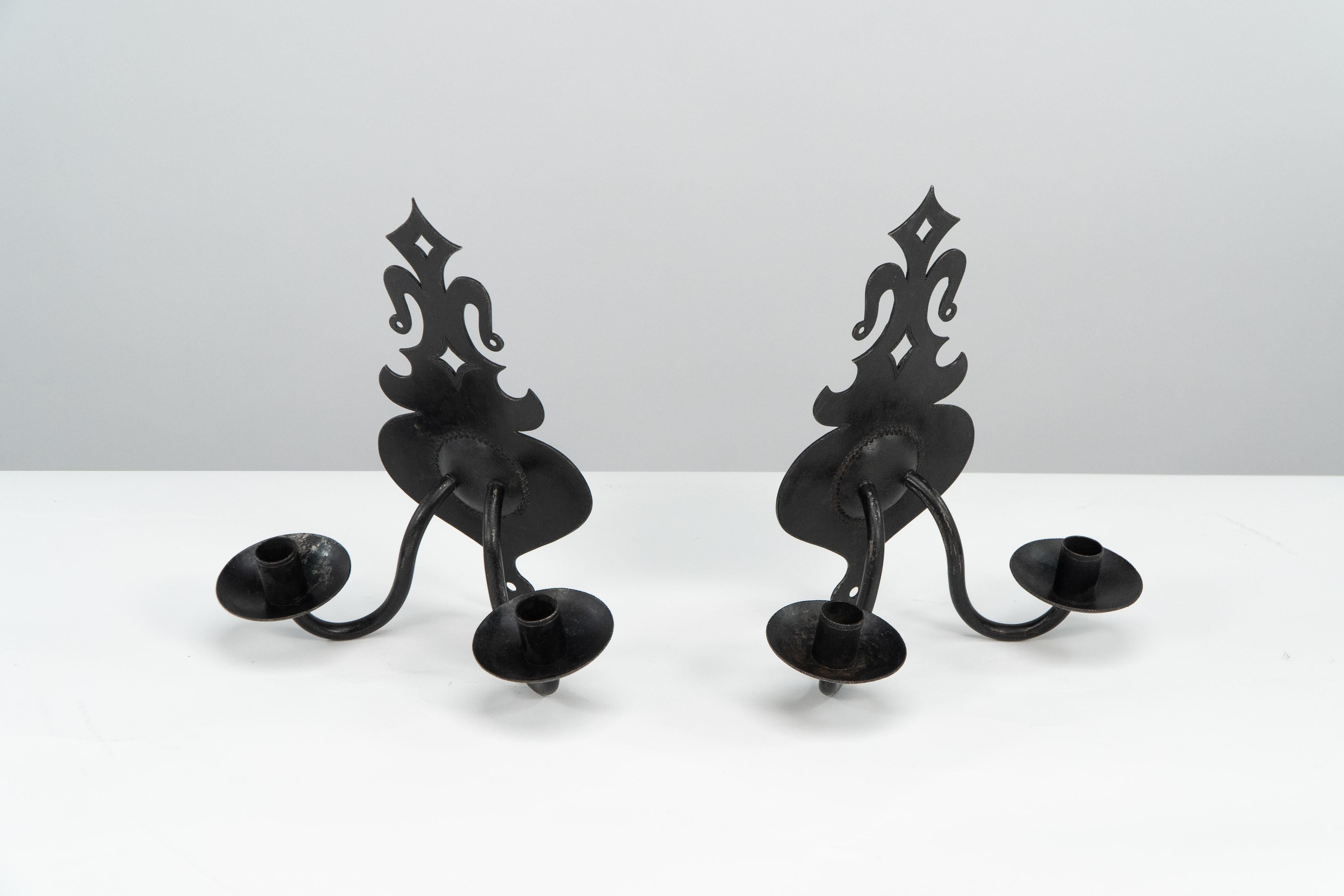 A rare signed pair of museum quality Arts and crafts steel wall sconces handmade by Alfred Bucknell. It is extremely rare to find pieces by Bucknell that are signed.
