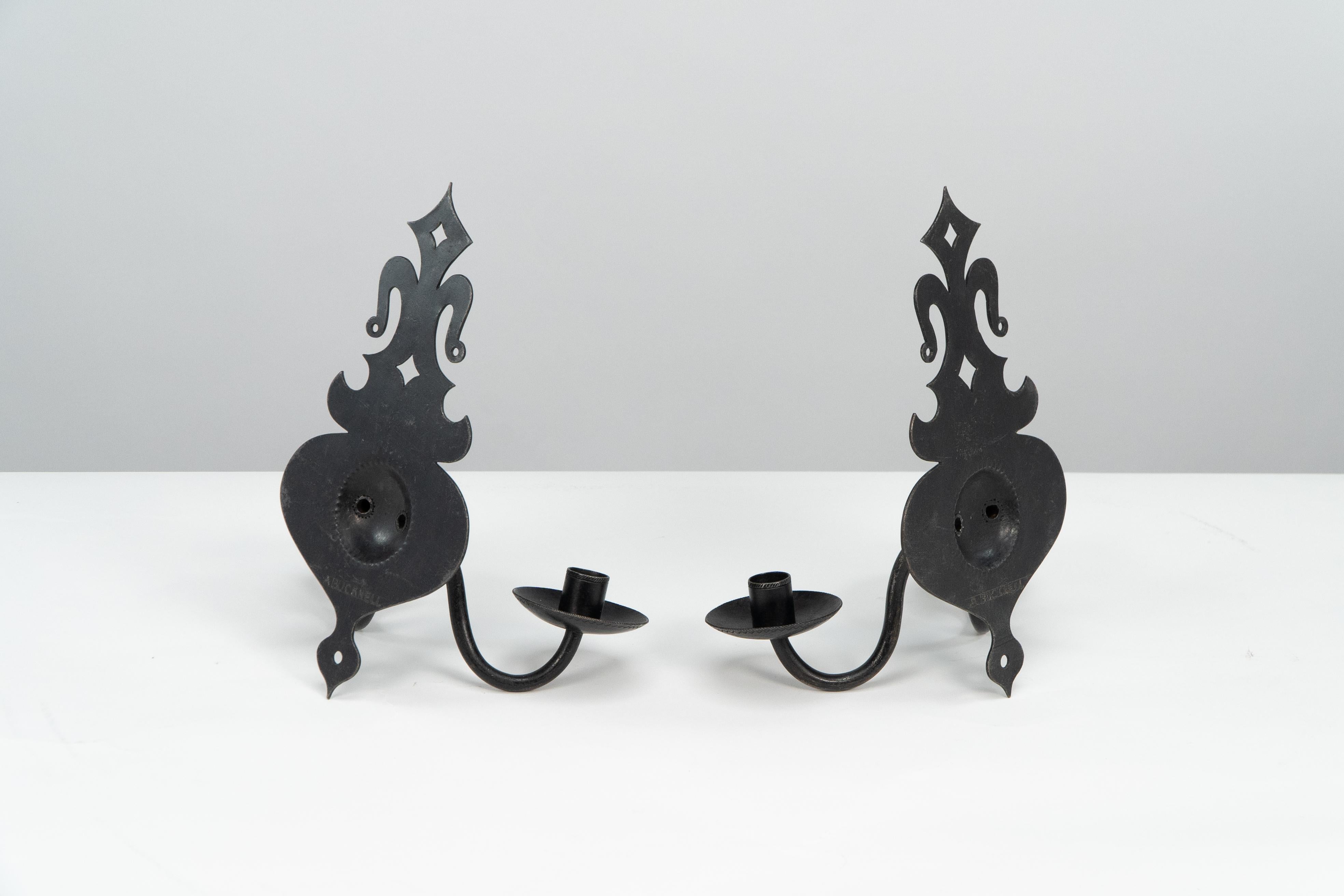 Early 20th Century Alfred Bucknell. A rare pair of Arts & Crafts museum quality steel wall sconces. For Sale