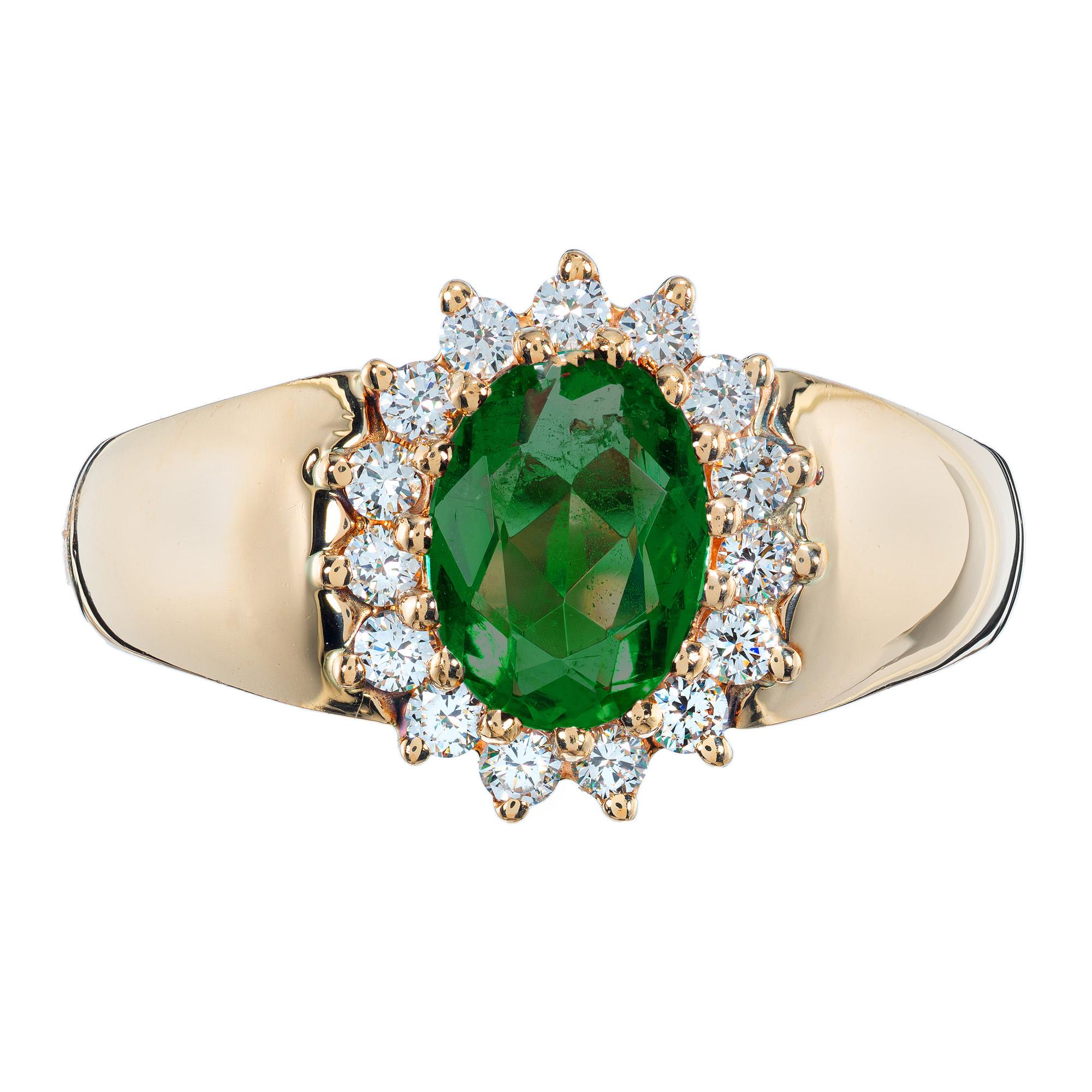 Alfred Butler classic oval Emerald and diamond engagement ring. .76ct oval cut center emerald set in a 14k yellow gold setting with a halo of 15 round brilliant cut diamonds. Alfred Butler was known as one of America’s finest manufacturing jewelers