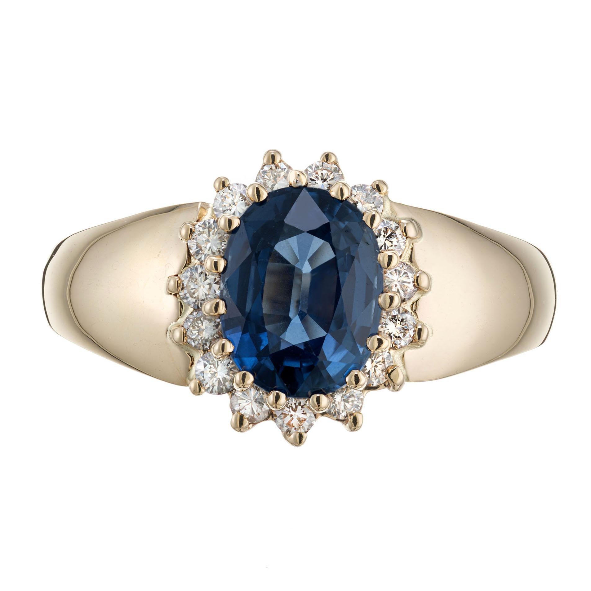Sapphire and diamond engagement ring. Oval Ceylon sapphire center stone in a 14k yellow gold setting with a halo of 18 round diamonds. Alfred Butler hallmark.  

1 oval Ceylon sapphire approx. total weight 2.00cts
18 round diamonds approx. total
