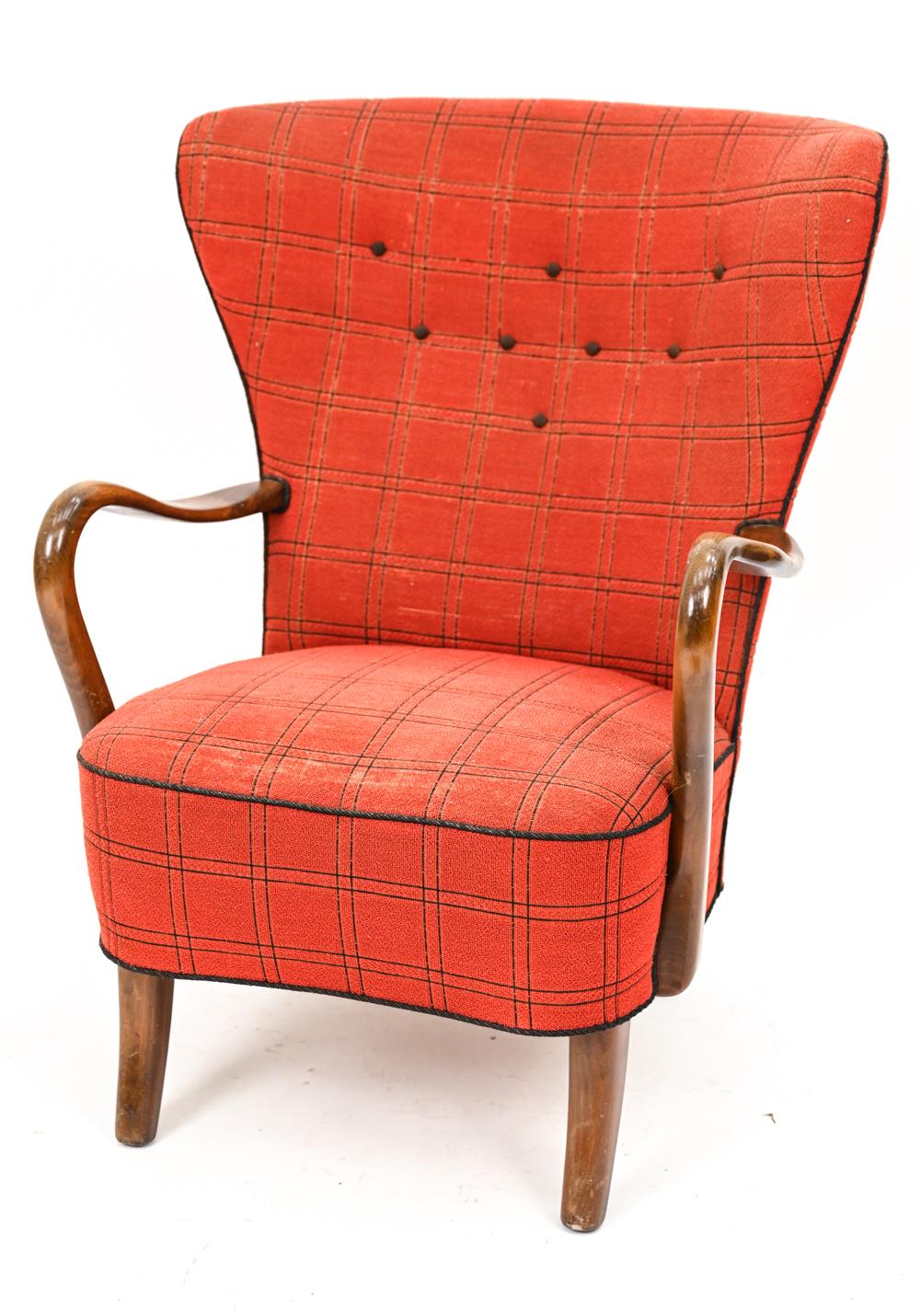 With this handsome chair, Alfred Christensen lends his Scandinavian mid-century sensibilities to offer a modern take on a traditional wingback form. An early example of Danish mid-century design, this transitional chair dates from the 1940's and