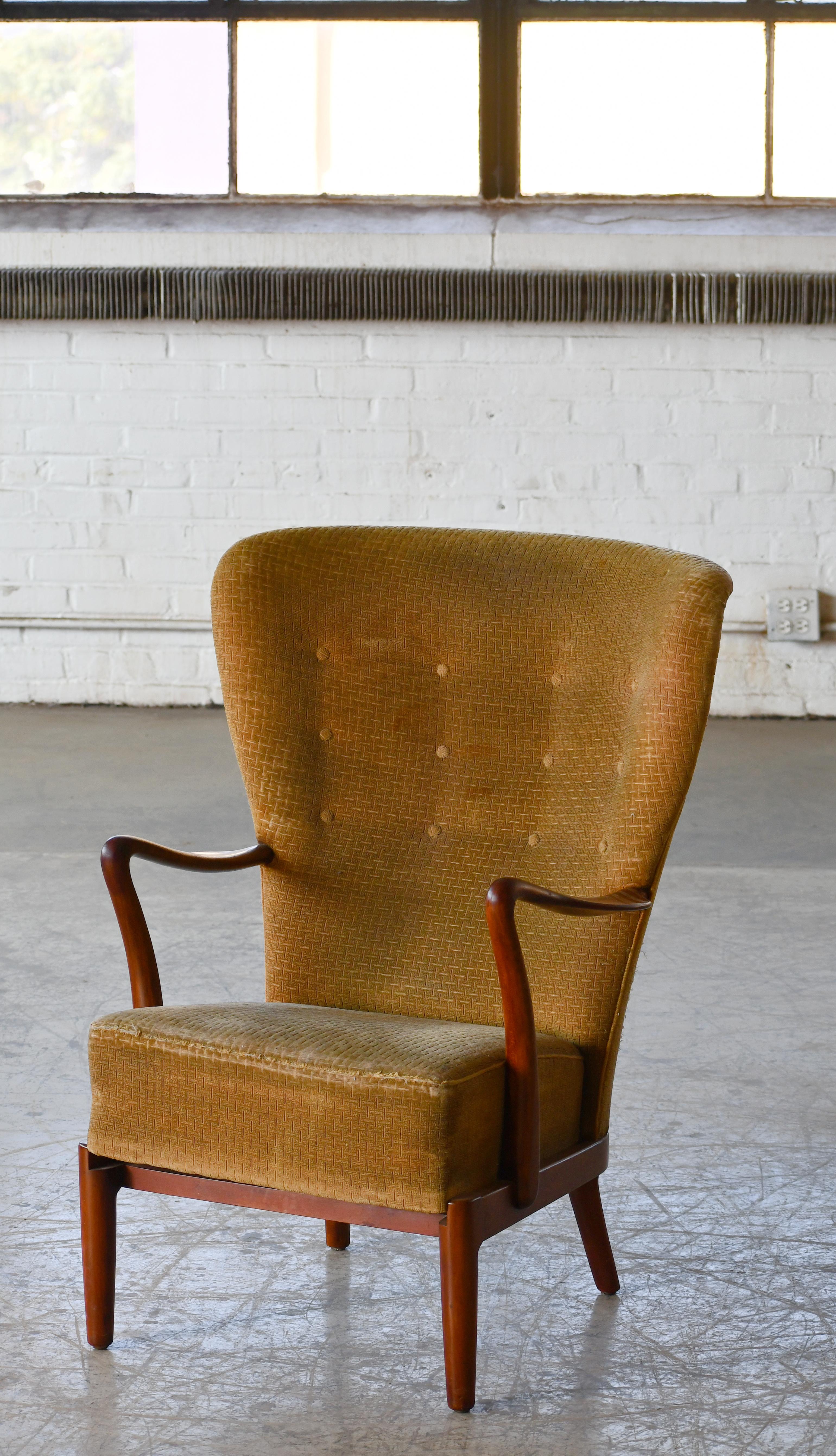 Classic elegant Danish High back lounge chair from the 1940s by Alfred Christensen for Slagelse Mobelvaerk with open armrests in beautifully curved stained beech. Nice slim elegant silhouette. Solid and sturdy construction.  This chair has copper